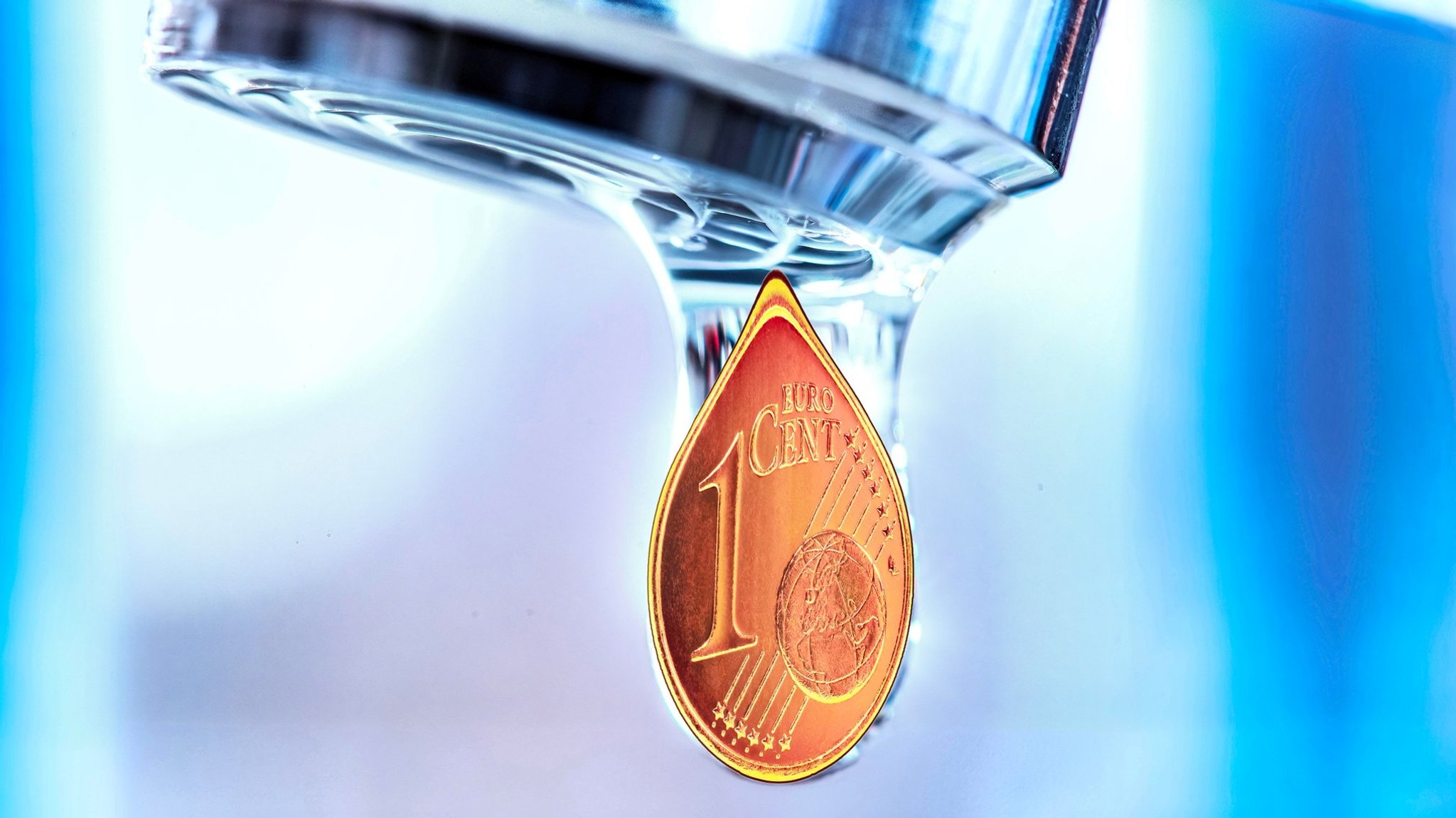 Aus einem Wasserhahn tropft ein Cent.