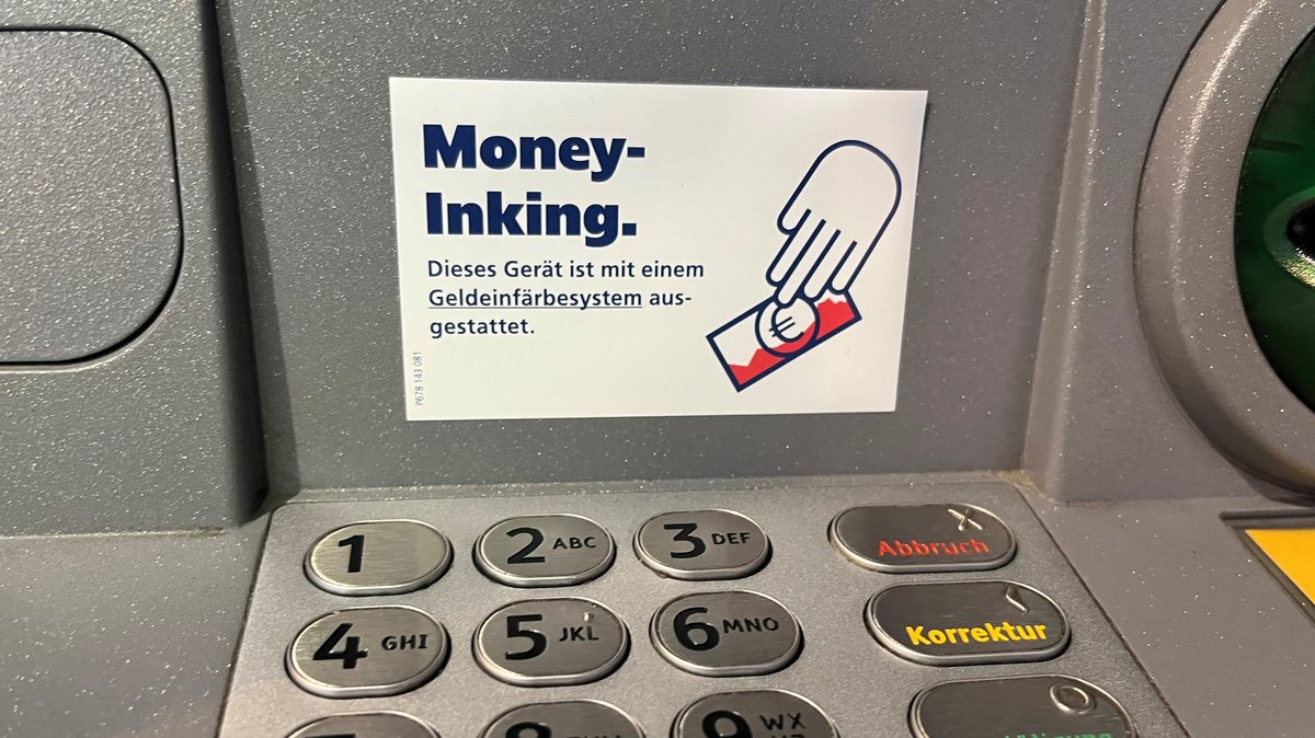 Money-Inking-Aufkleber an einem Geldautomaten