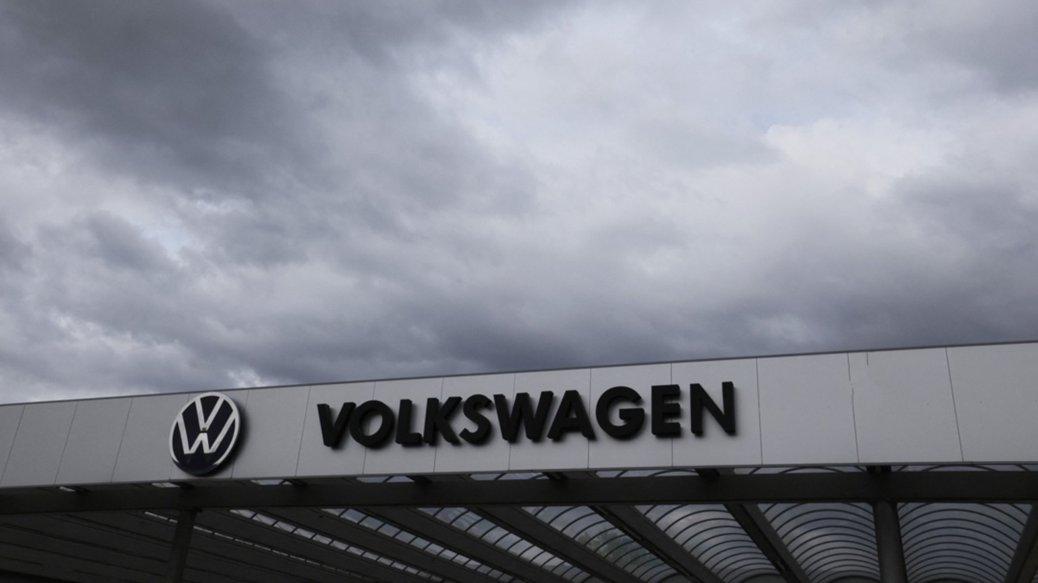 Dunkle Wolken über einem Werkstor von Volkwagen | Bild: dpa-Bildfunk/Bodo Schackow Dunkle Wolken über einem Werkstor von Volkwagen