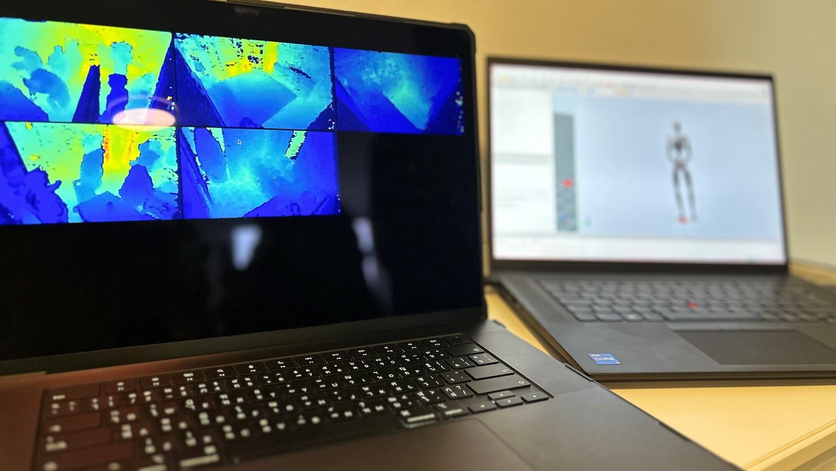 Zwei Laptops stehen auf einem Tische, beide Bildschirme zeigen Bewegungen des Menschen.  