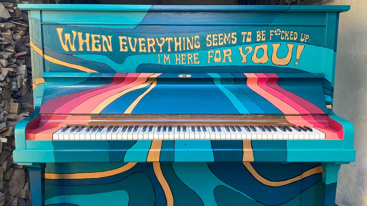 Ein in Blau- und Rot-Tönen bemaltest Klavier auf dem steht: When everything seem to bei f*ucked up: I'm here for you