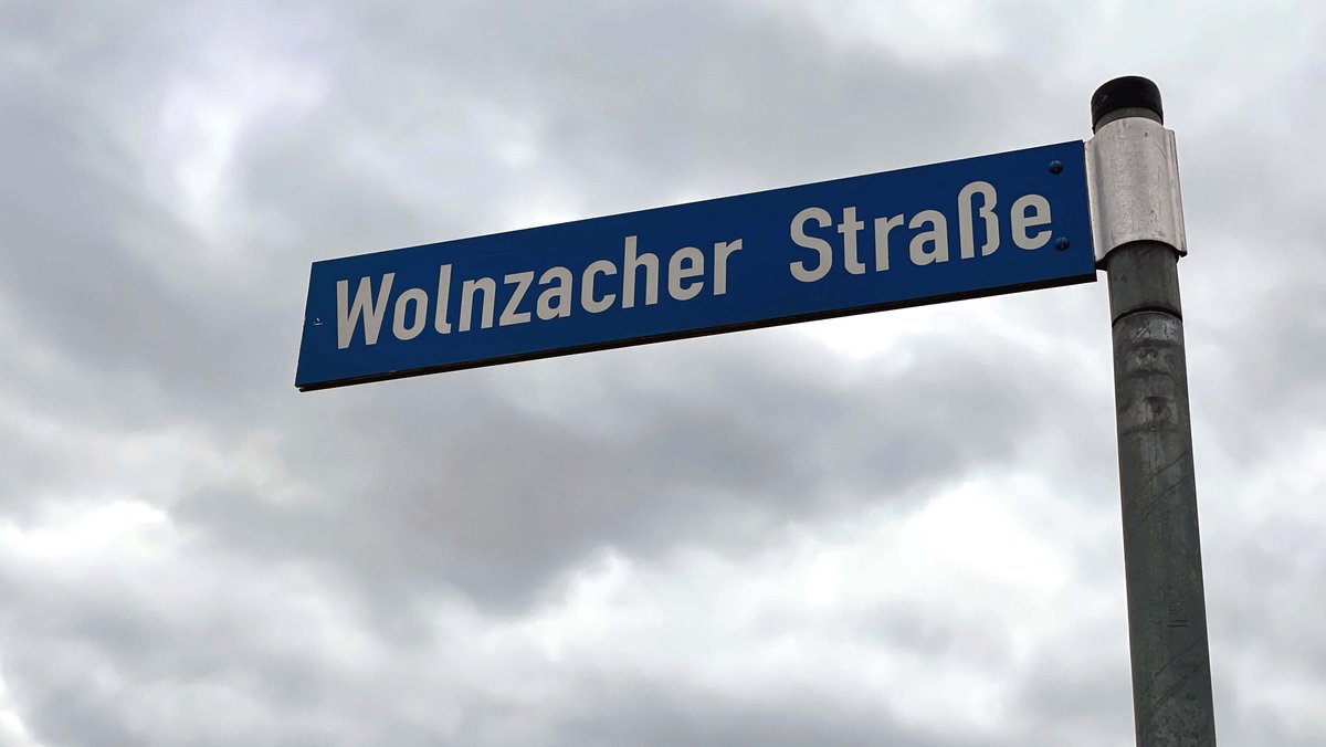 Das Straßenschild "Wolnzacher Straße" vor bedecktem Himmel.