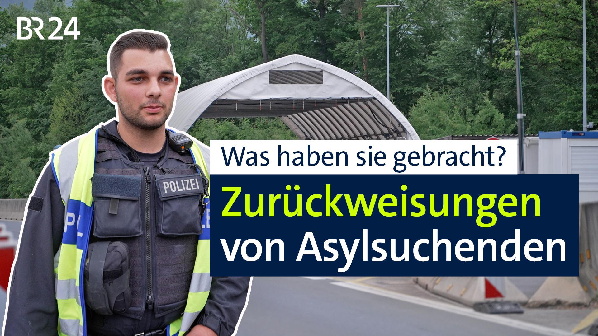Ein Grenzpolizist steht mit Blick auf den entgegenkommenden Verkehr vor einem weißen Zelt für Grenzkontrollen