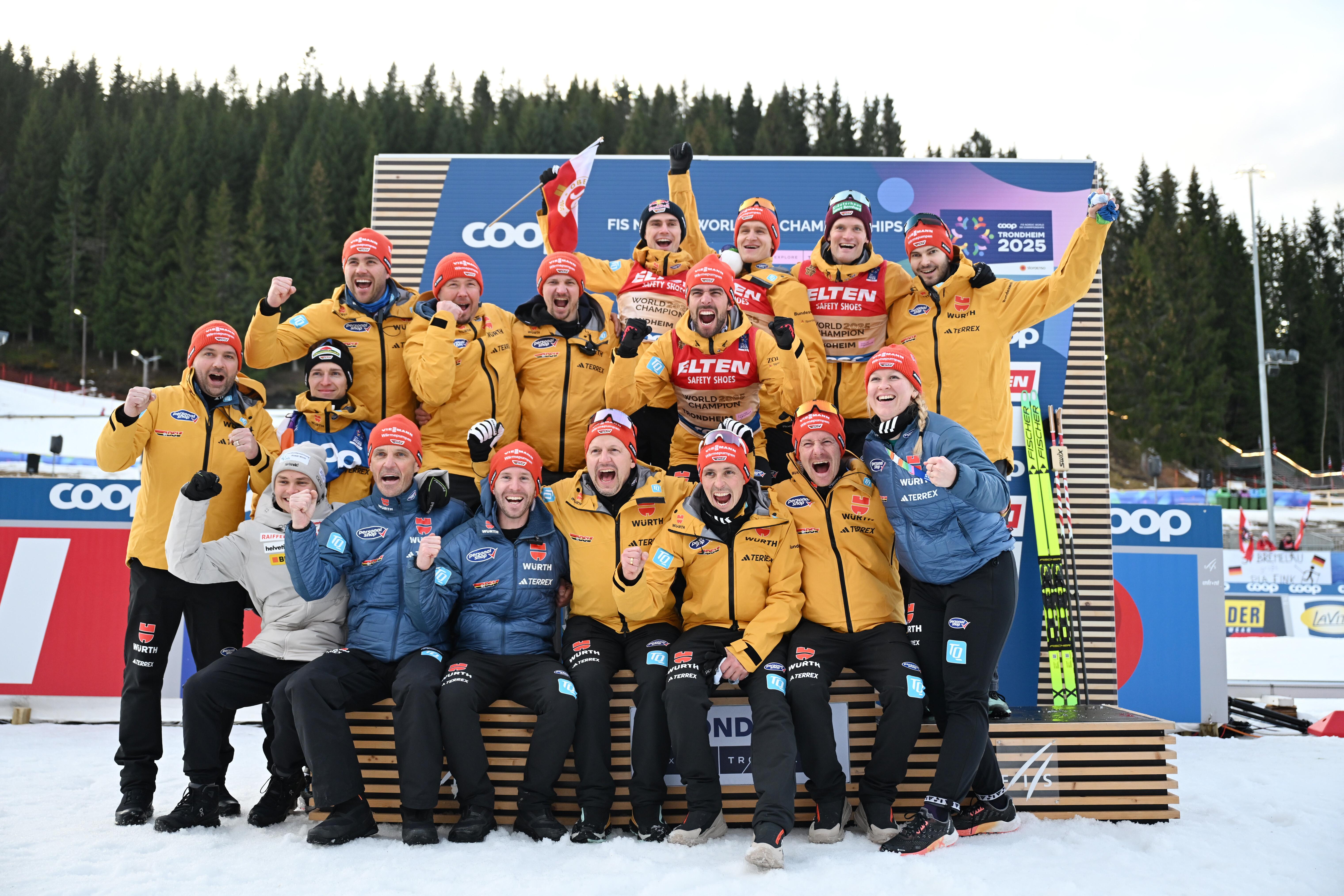 Johannes Rydzek, Wendelin Thannheimer, Julian Schmid und Vinzenz Geiger, die Trainer und Betreuer bejubeln den Sieg