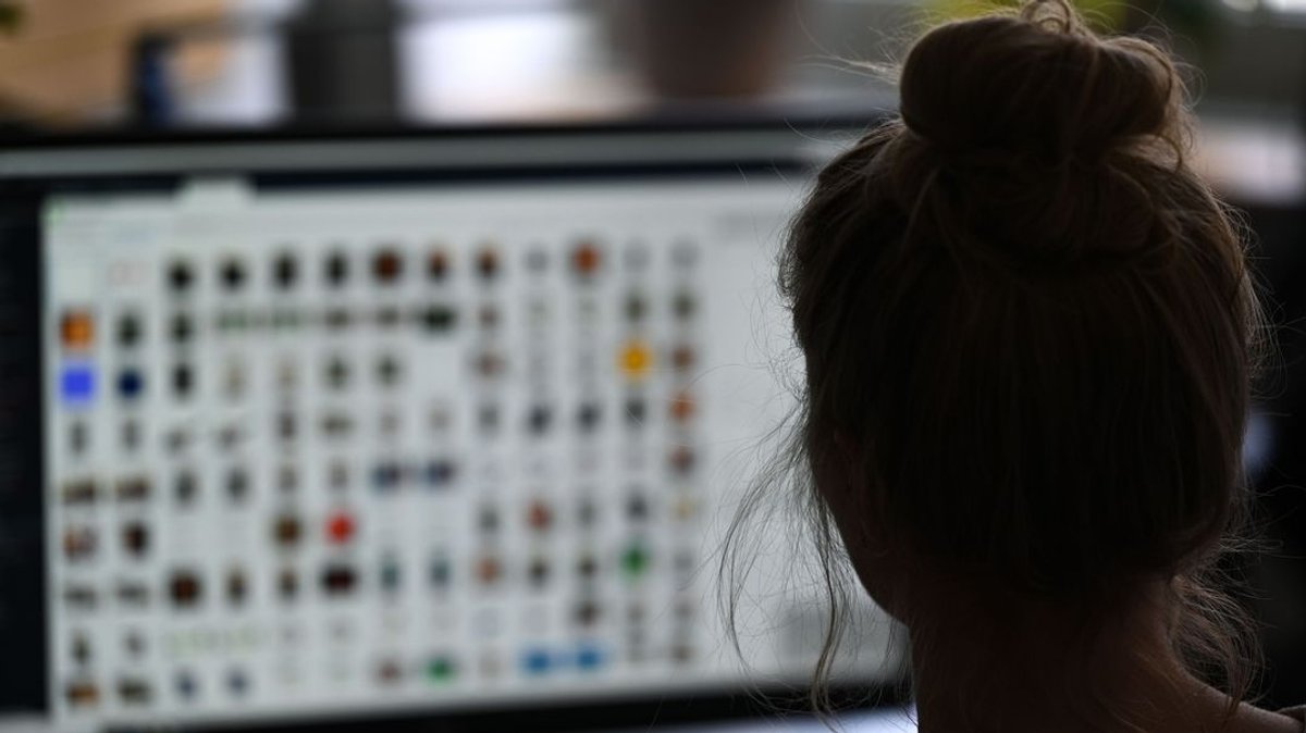 Eine Frau blickt auf einen Bildschirm