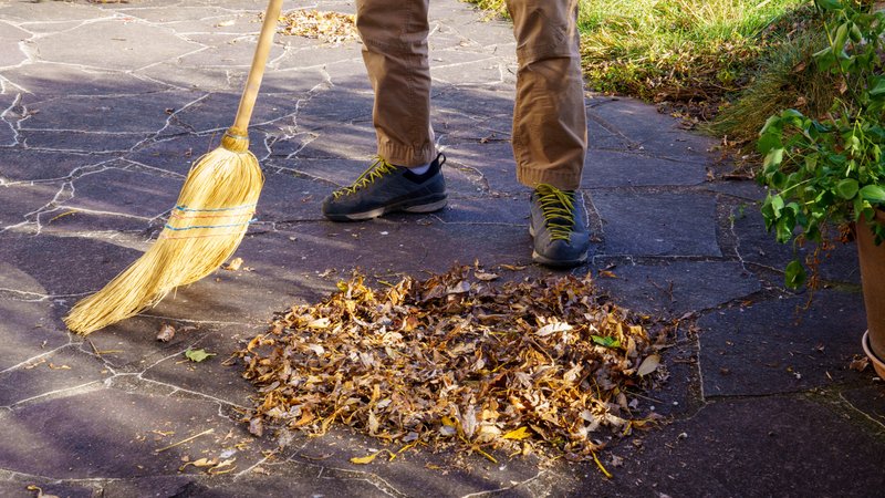 ARCHIV (09.11.2024) Gartenarbeit: Laub auf der Terrasse mit Strohbesen zusammenkehren und Laubhaufen bilden) | Bild: picture alliance / Zoonar | Sandra Altkuckatz ARCHIV (09.11.2024) Gartenarbeit: Laub auf der Terrasse mit Strohbesen zusammenkehren und Laubhaufen bilden)