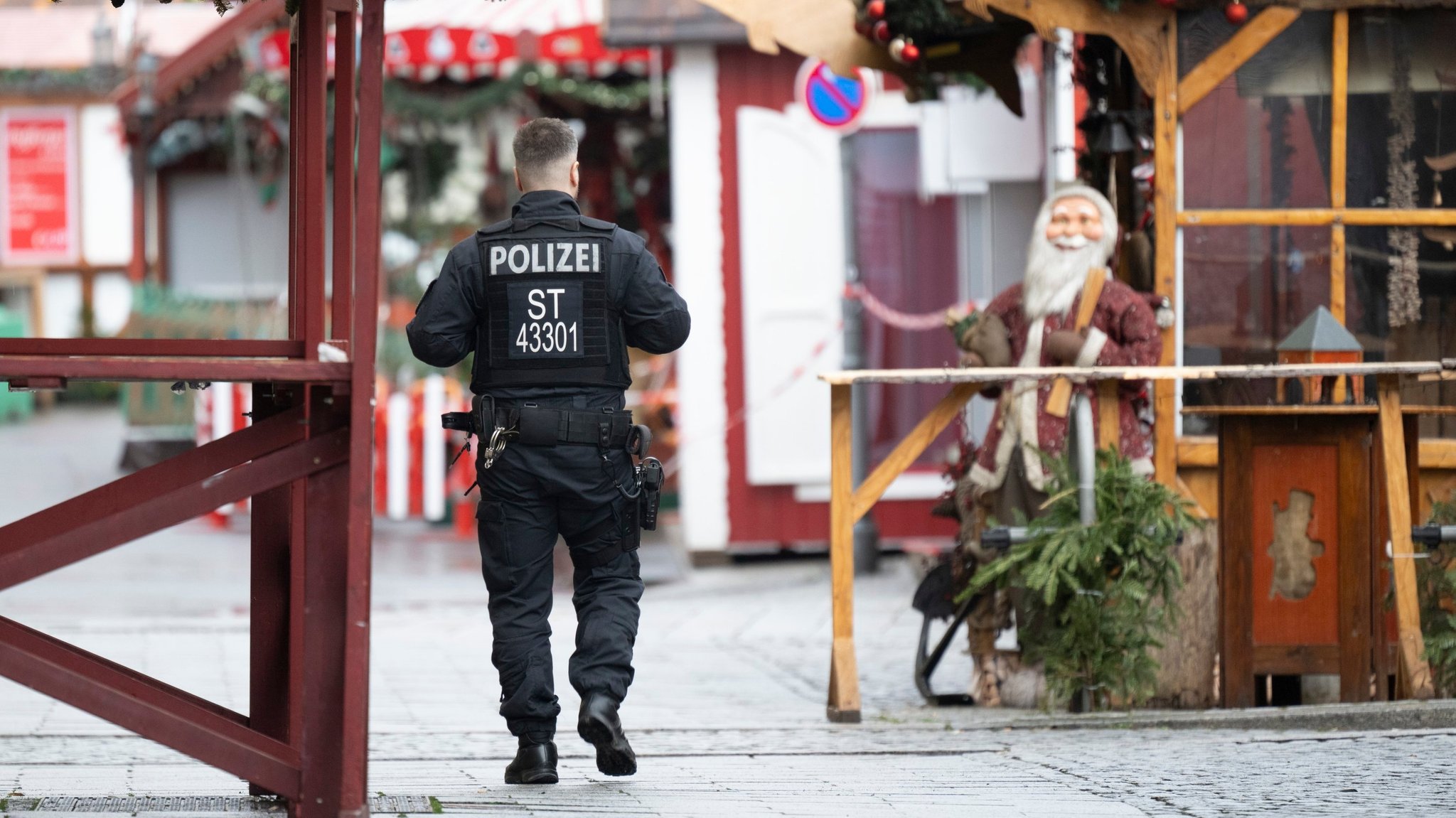 22.12.2024, Sachsen-Anhalt, Magdeburg: Ein Polizist geht über den gesperrten Weihnachtsmarkt. Am 20. Dezember 2024 ist auf dem Weihnachtsmarkt in Magdeburg ein Autofahrer in eine Menschengruppe gefahren. Es gab mehrere Tote und Verletzte. Foto: Sebastian Kahnert/dpa +++ dpa-Bildfunk +++