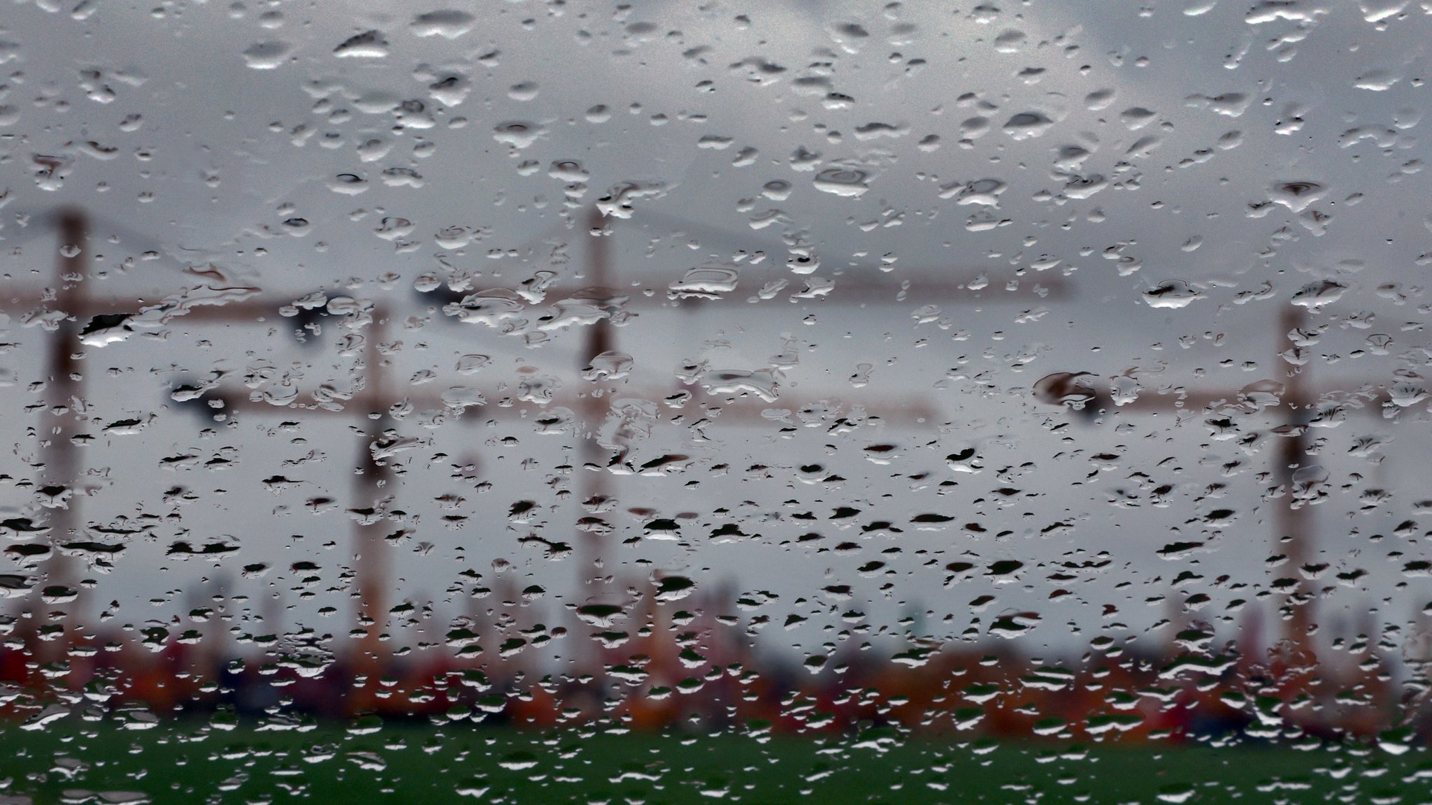 Trübe Konjunkturaussichten: Bayern, Mindelheim: Hinter einer regennassen Scheibe sind Baukräne auf dem Gelände eines Kranservice unter dichten Wolken zu sehen. | Bild: Karl-Josef Hildenbrand/dpa Trübe Konjunkturaussichten: Bayern, Mindelheim: Hinter einer regennassen Scheibe sind Baukräne auf dem Gelände eines Kranservice unter dichten Wolken zu sehen.