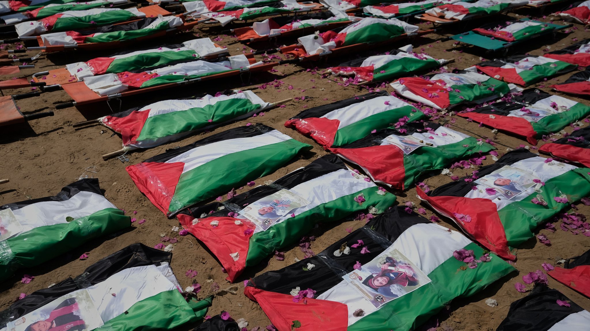 SYMBOLBILD - 04.08.2026, Palästinensische Gebiete, Gaza Stadt: Beerdigung von Leichen im Gazastreifen, die mit palästinensischen Flaggen bedeckt sind. 