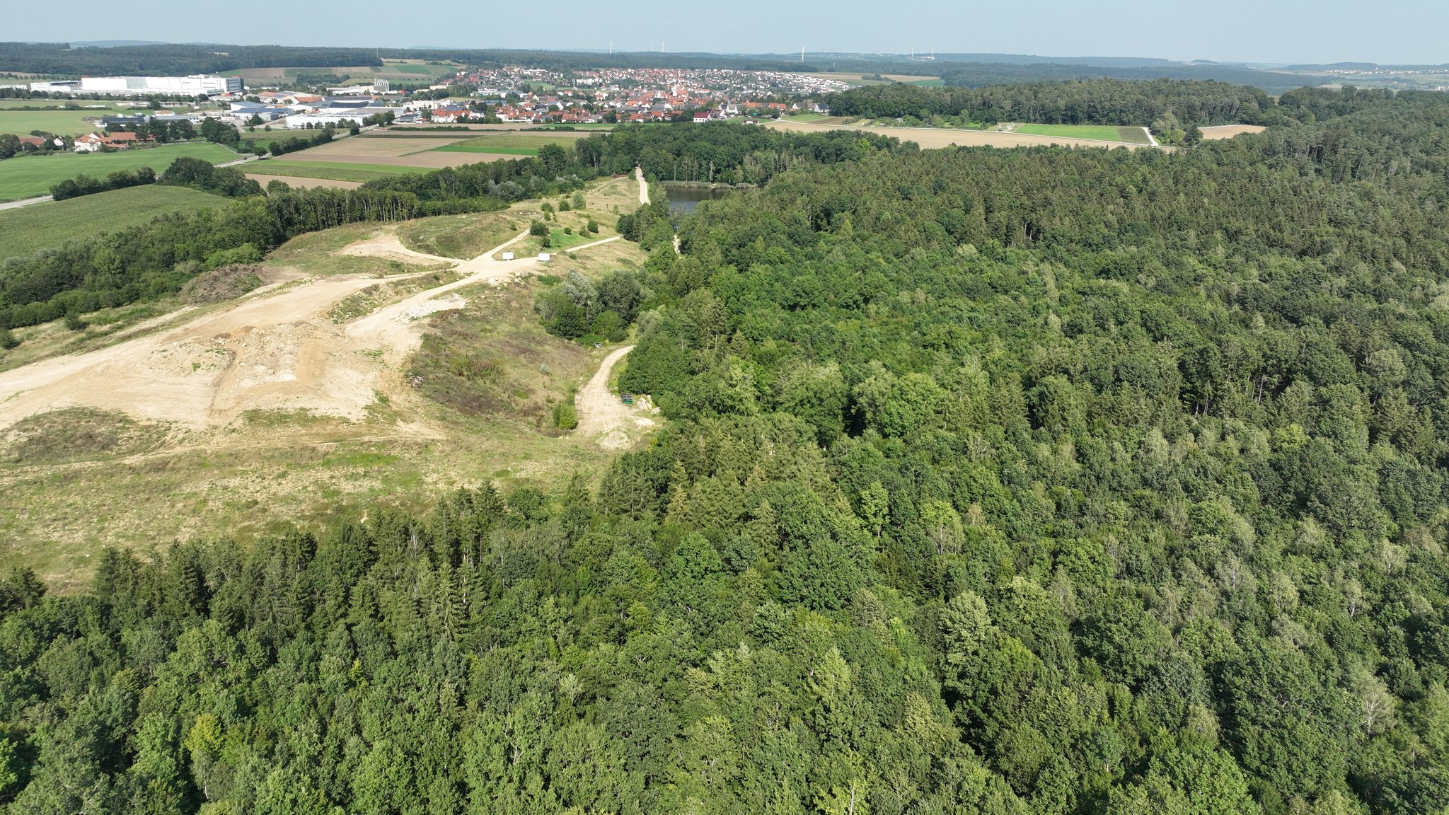 Blick auf die bestehende Deponie und den Wald daneben, der für die Erweiterung abgeholzt werden könnte.