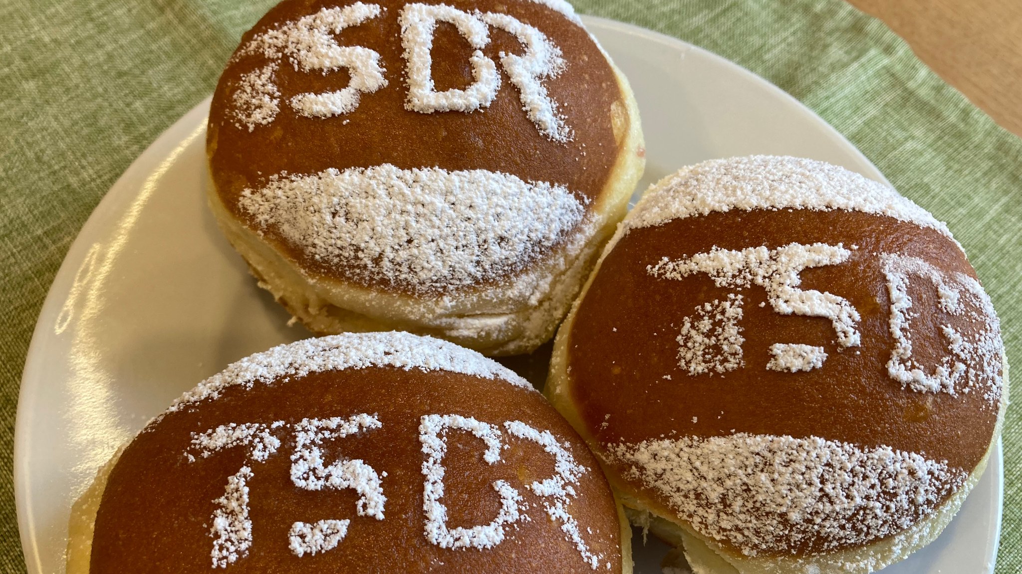 Krapfen, auf denen mit Puderzucker "75 BR" steht.