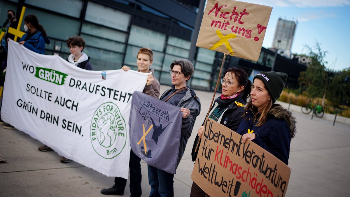 16.10.2022, Bonn: Klimaaktivisten protestieren vor der Veranstaltungshalle beim Grünen-Bundesparteitag.