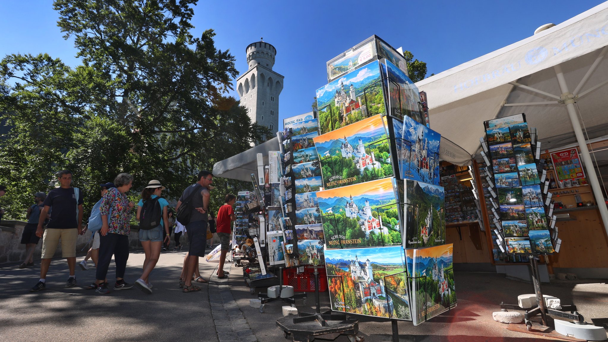 Touristen an einem Souvenir-Geschäft vor dem Schloss Neuschwanstein.