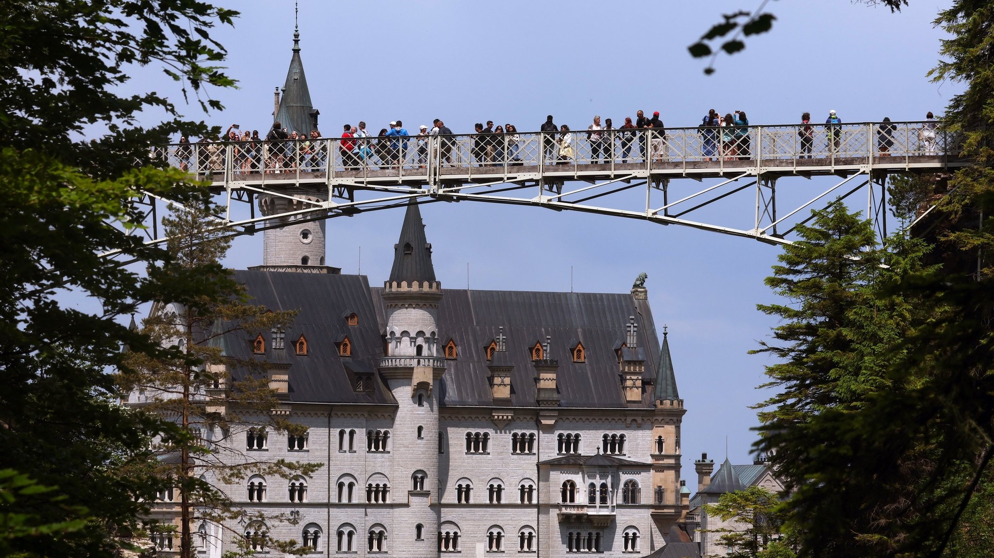 Tourists on the Marienbrücke near Neuschwanstein castle in bavaria