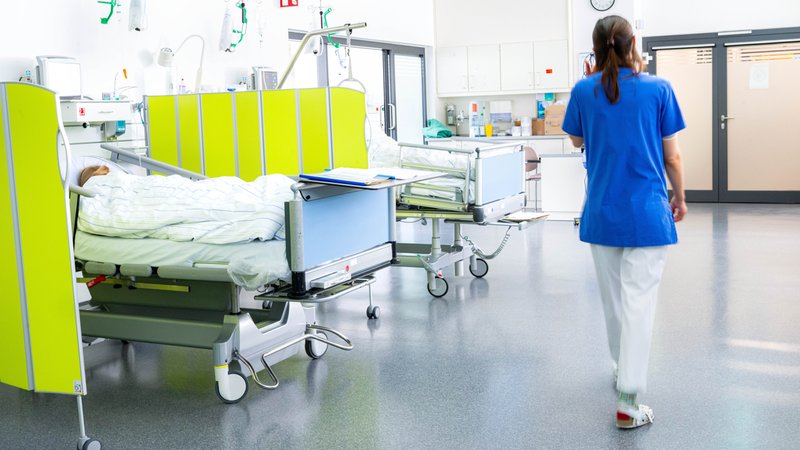 Eine Pflegerin läuft durch eine Klinik. | Bild: picture alliance/dpa | Sina Schuldt Eine Pflegerin läuft durch eine Klinik.