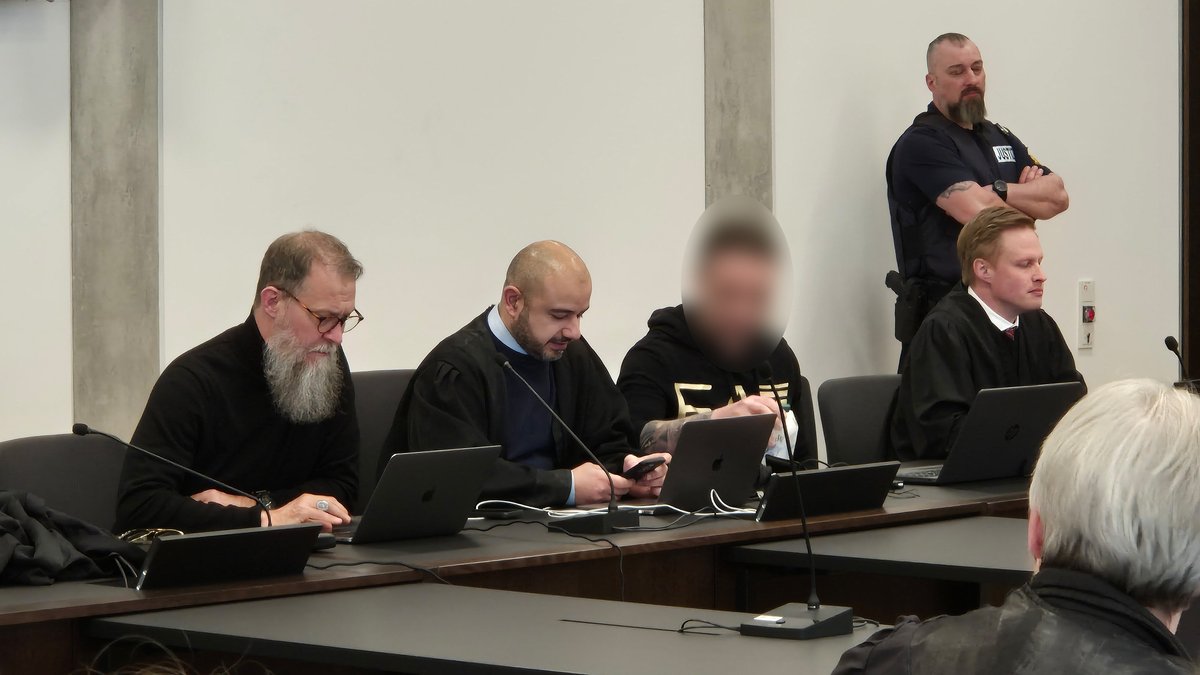 Der Angeklagte (3. von links) mit seinen Anwälten im Gerichtssaal