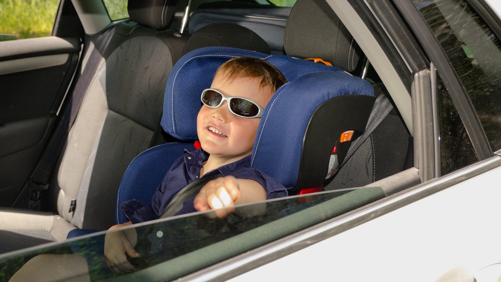 Kind sitzt im Kindersitz hinten im Auto und hat eine Sonnenbrille auf. | Bild: colourbox.de Kind sitzt im Kindersitz hinten im Auto und hat eine Sonnenbrille auf.