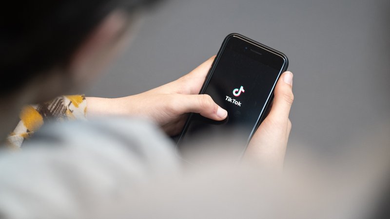 Eine Jugendliche schaut auf ein Smartphone mit angezeigtem TikTok-Logo. | Bild: picture alliance/dpa | Hannes P. Albert Eine Jugendliche schaut auf ein Smartphone mit angezeigtem TikTok-Logo.