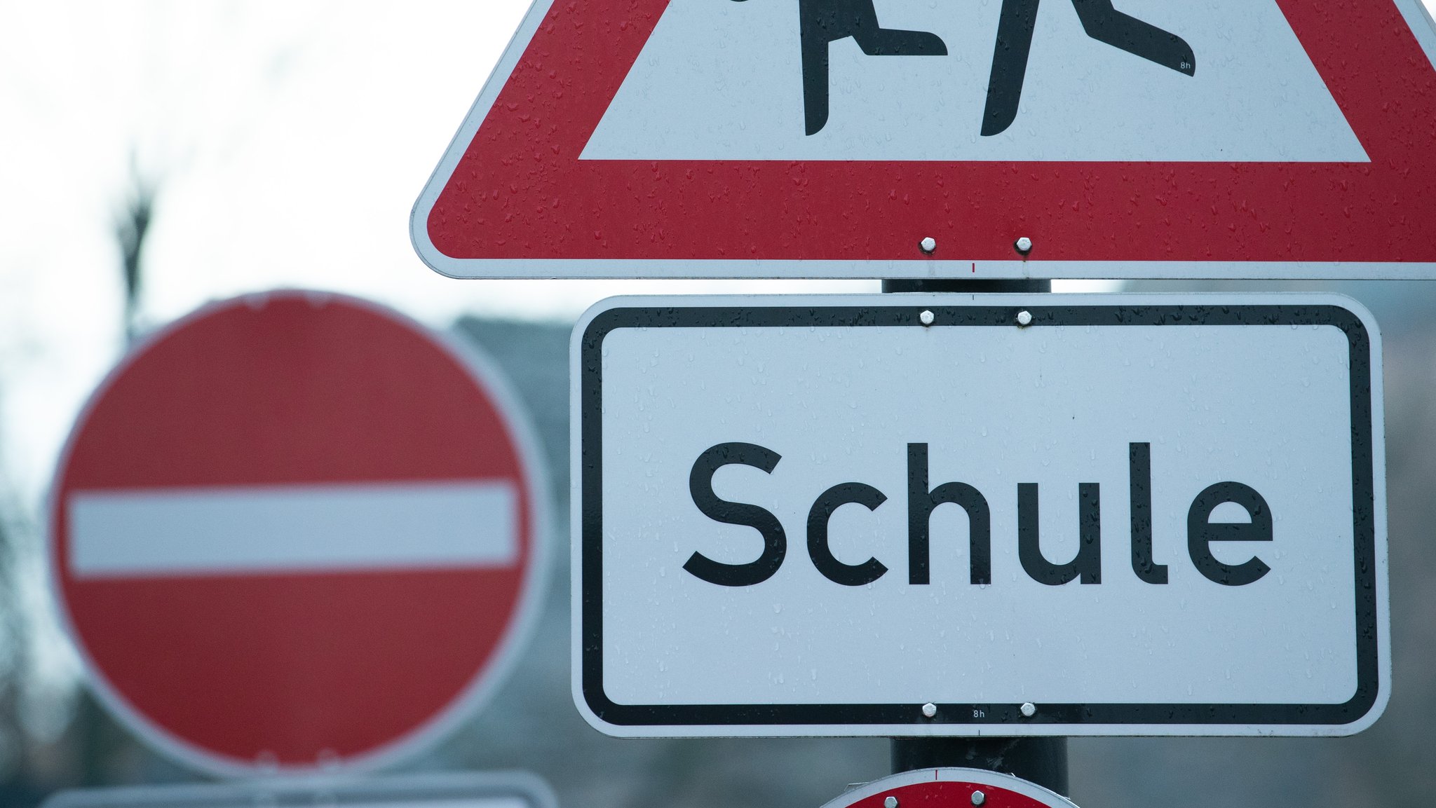 Ein Schild mit der Aufschrift "Schule" vor einem "Durchfahrt verboten"-Schild.