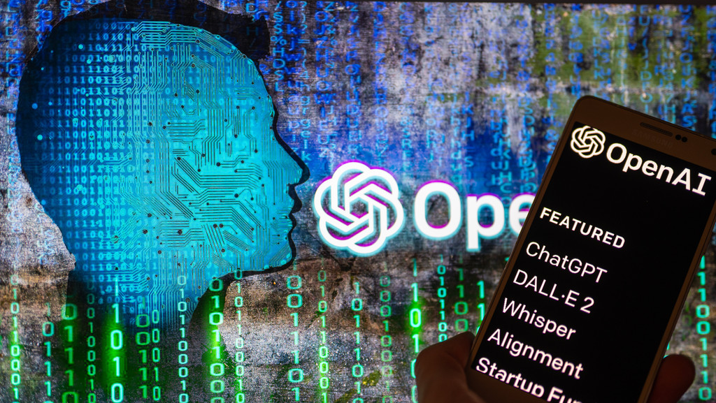 OpenAI logo seen on screen with ChatGPT website displayed on mobile 