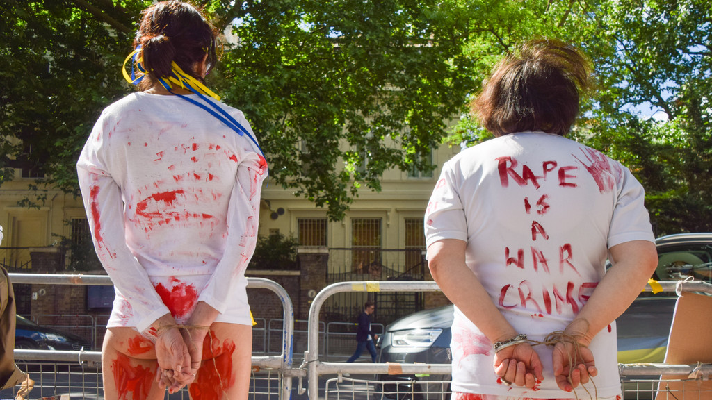 Frauen mit weißen T-Shirts, auf denen "Rape is a War Crime" zu lesen ist