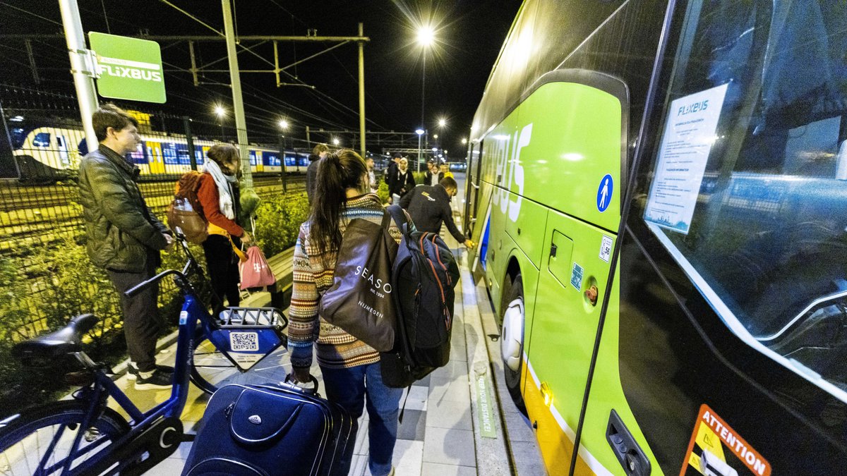 Reisende versammeln sich am Einstiegspunkt am Bahnhof Maastricht zur Abfahrt des Flixbus nach Kiew. 