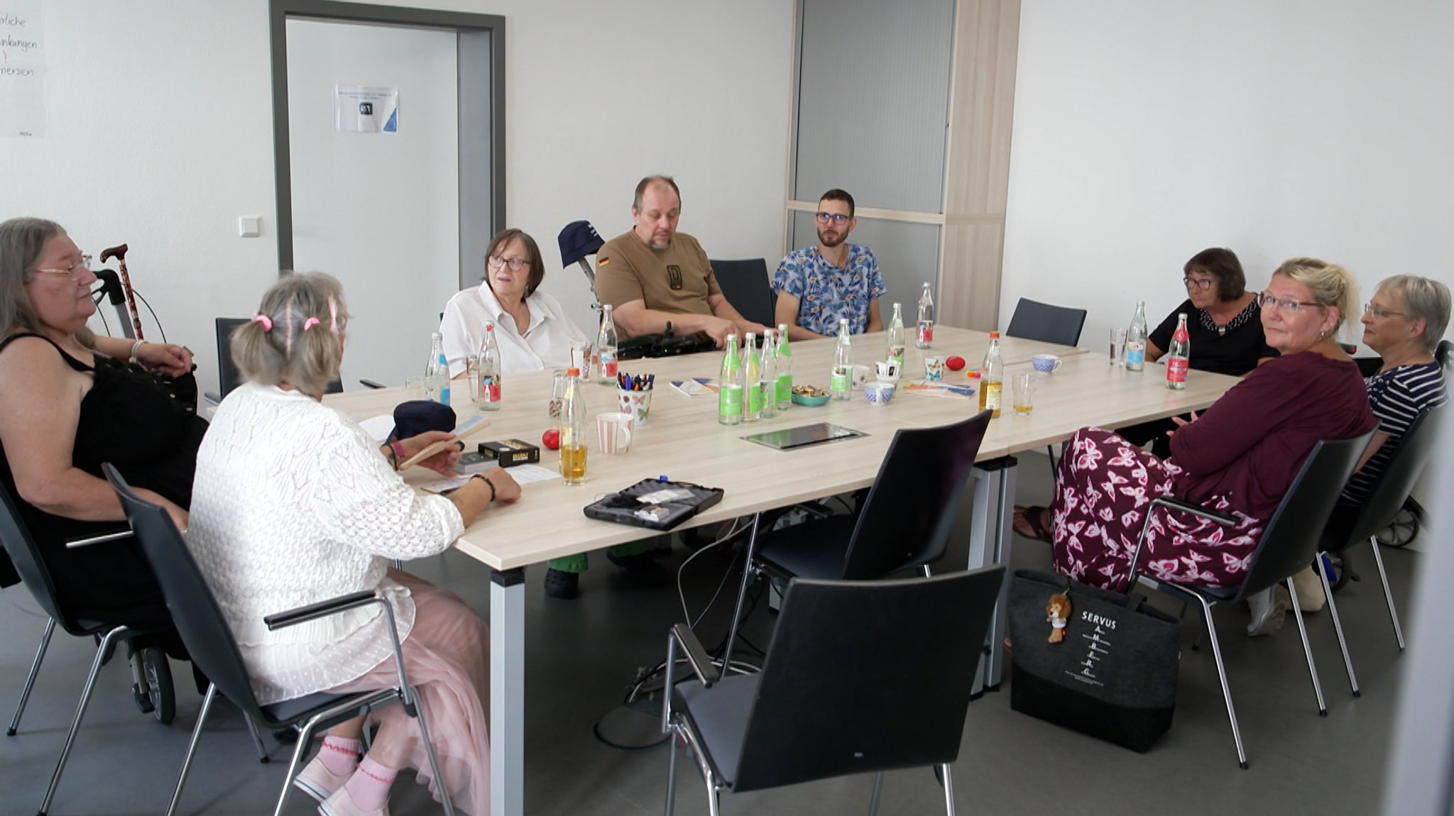 Mehrere Menschen sitzen um einen Tisch herum. | Bild: Bernd Stuhlmüller/BR Mehrere Menschen sitzen um einen Tisch herum.