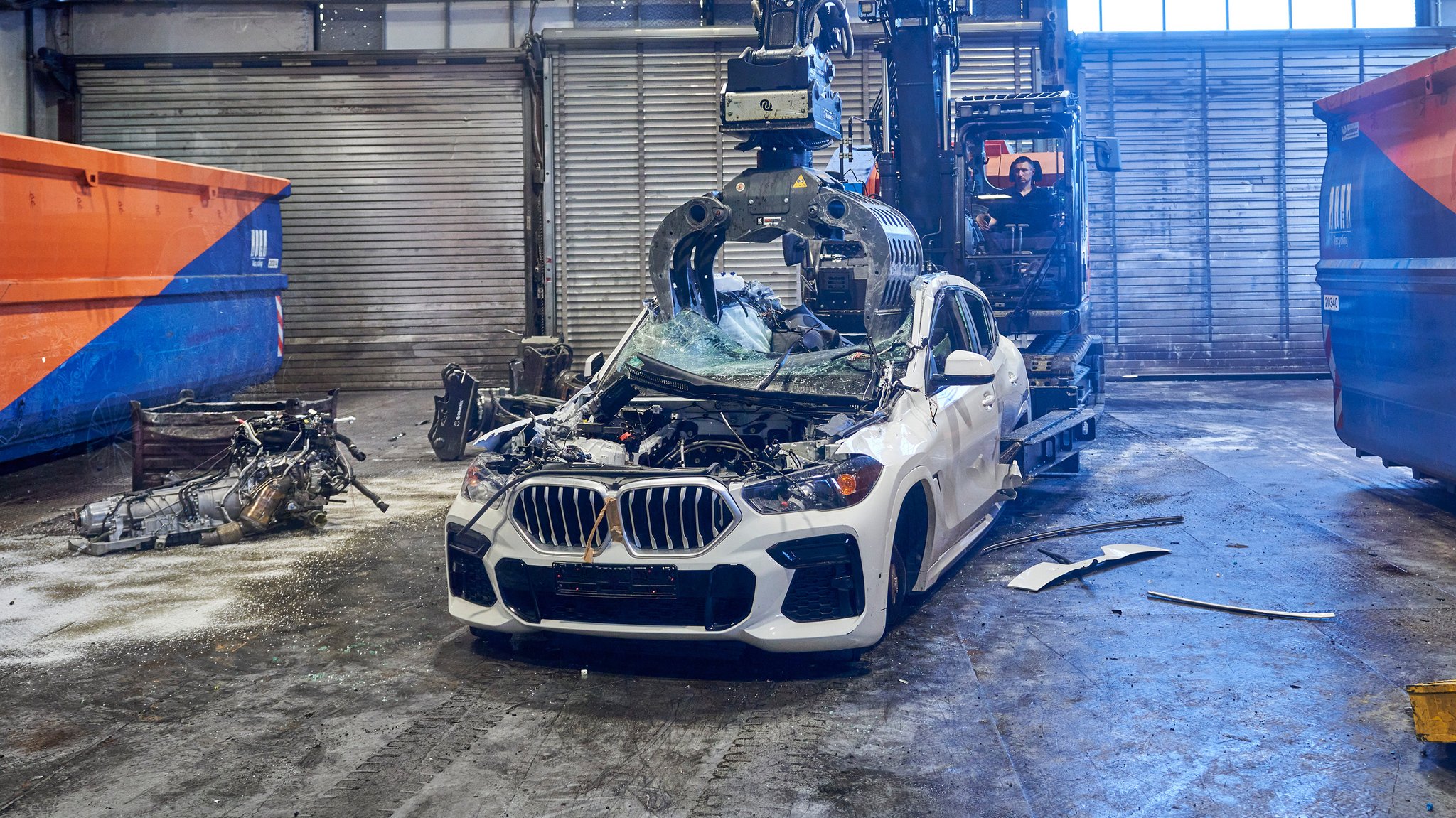 Ein Auto wird mit Hilfe eines Greifarms zerlegt