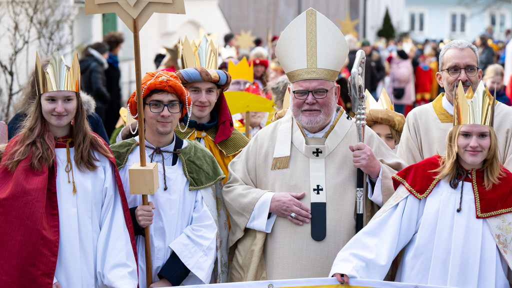 Kardinal Reinhard Marx (4.v.l.), Erzbischof von München und Freising, steht nach dem Aussendungsgottesdienst für die Sternsingeraktion 2023 mit den Sternsingern für ein Foto zusammen. 