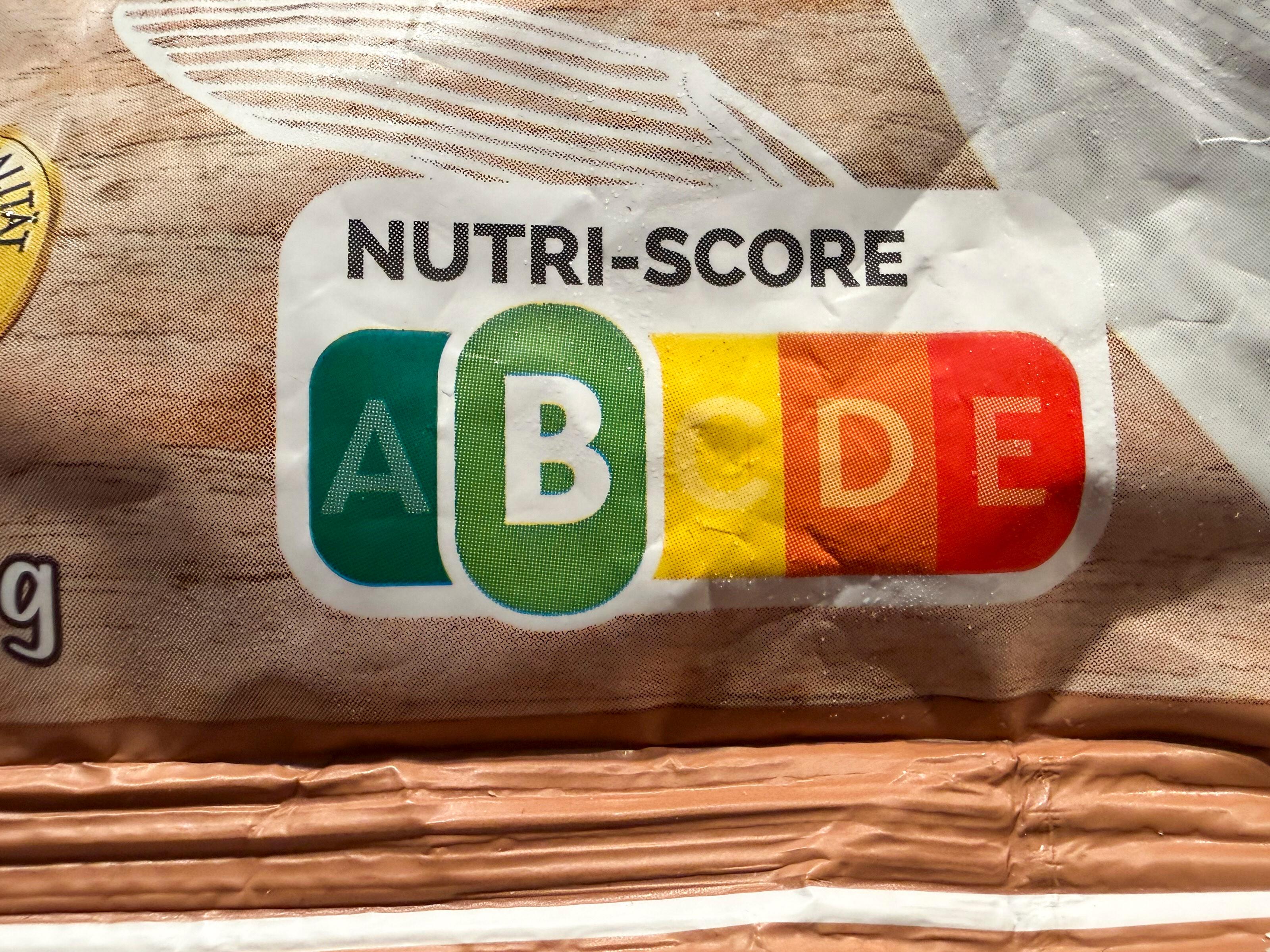 Auf dem Bild ist ein Nutri-Score-Label auf einer Lebensmittelverpackung zu sehen. Die Skala reicht von A (grün) bis E (rot), wobei der Buchstabe B in Grün hervorgehoben ist.