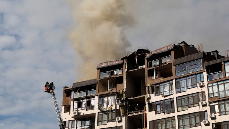 Feuerwehrleute löschen einen Brand in einem Wohnhaus in Kiew, das von einer russischen Rakete getroffen wurde | Bild:Reuters/Valentyn Ogirenko 