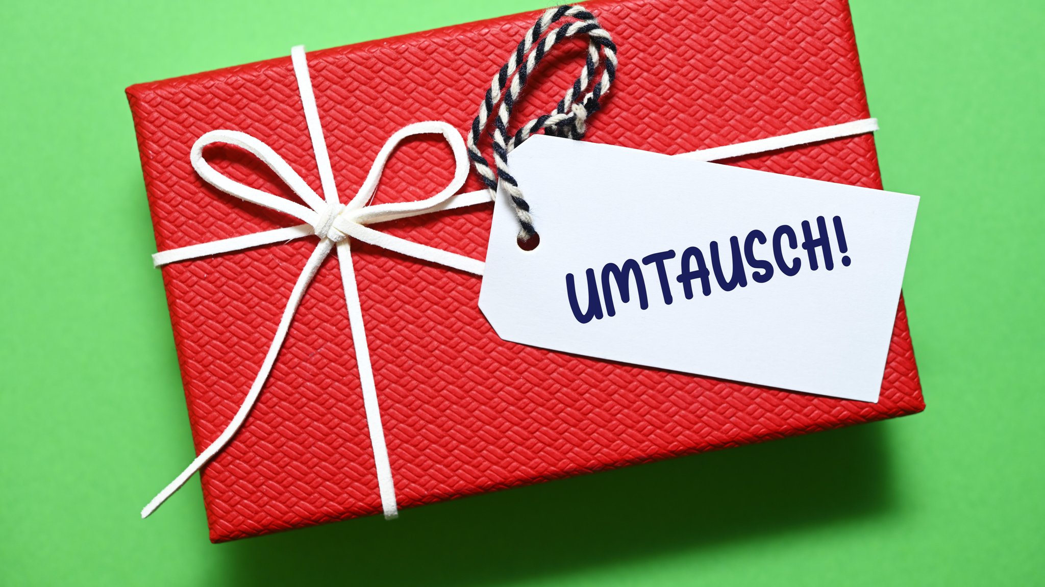 Ein roter Geschenkkarton mit einem Zettel mit der Aufschrift "umtausch2