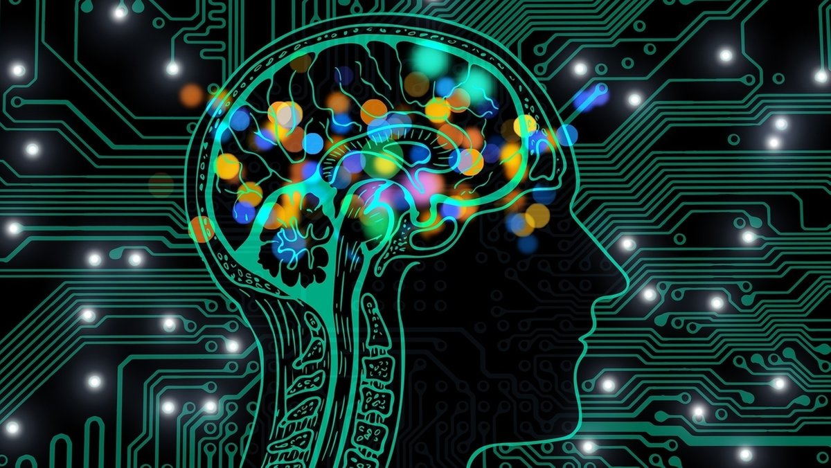 Grafik zu einem Gehirn im menschlichen Kopf mit bunten Farbtupfern 