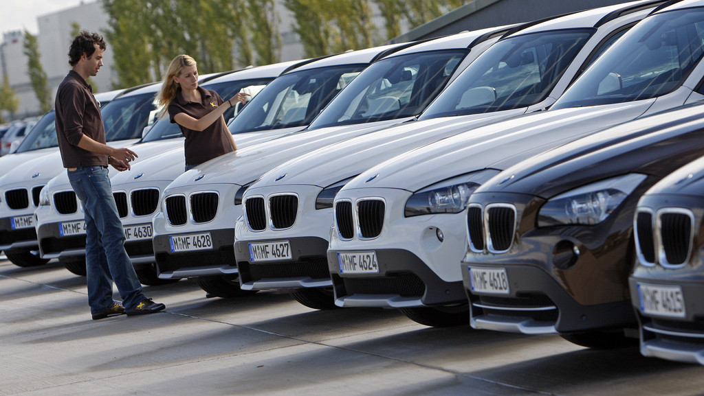 Ein junges Paar betrachtet den BMW X1. 
