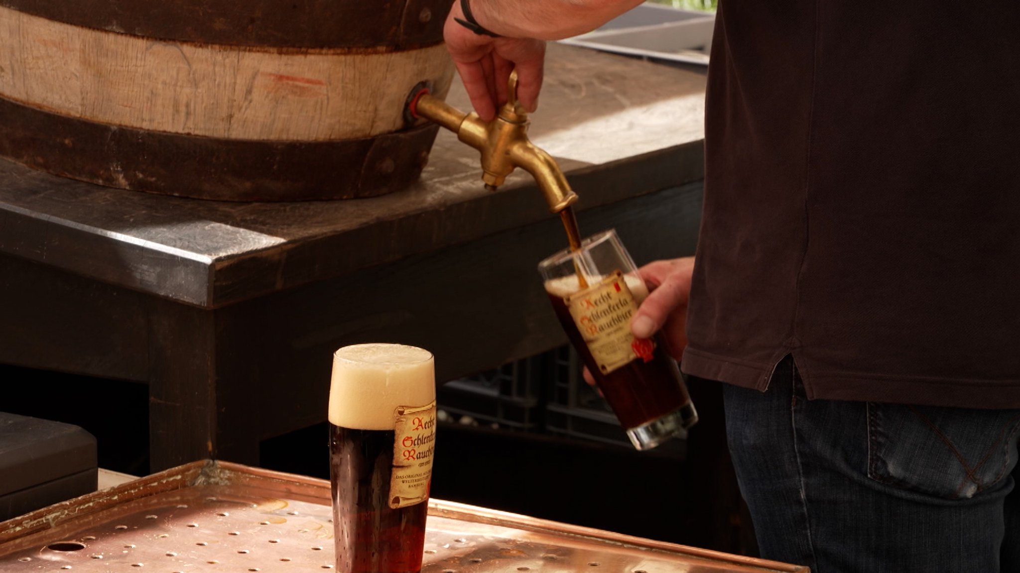 Bier fließt aus einem Zapfhahn in ein Glas.