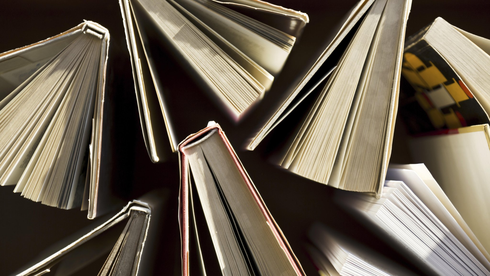 (Symbolbild) Ein umfallender Bücherstapel.