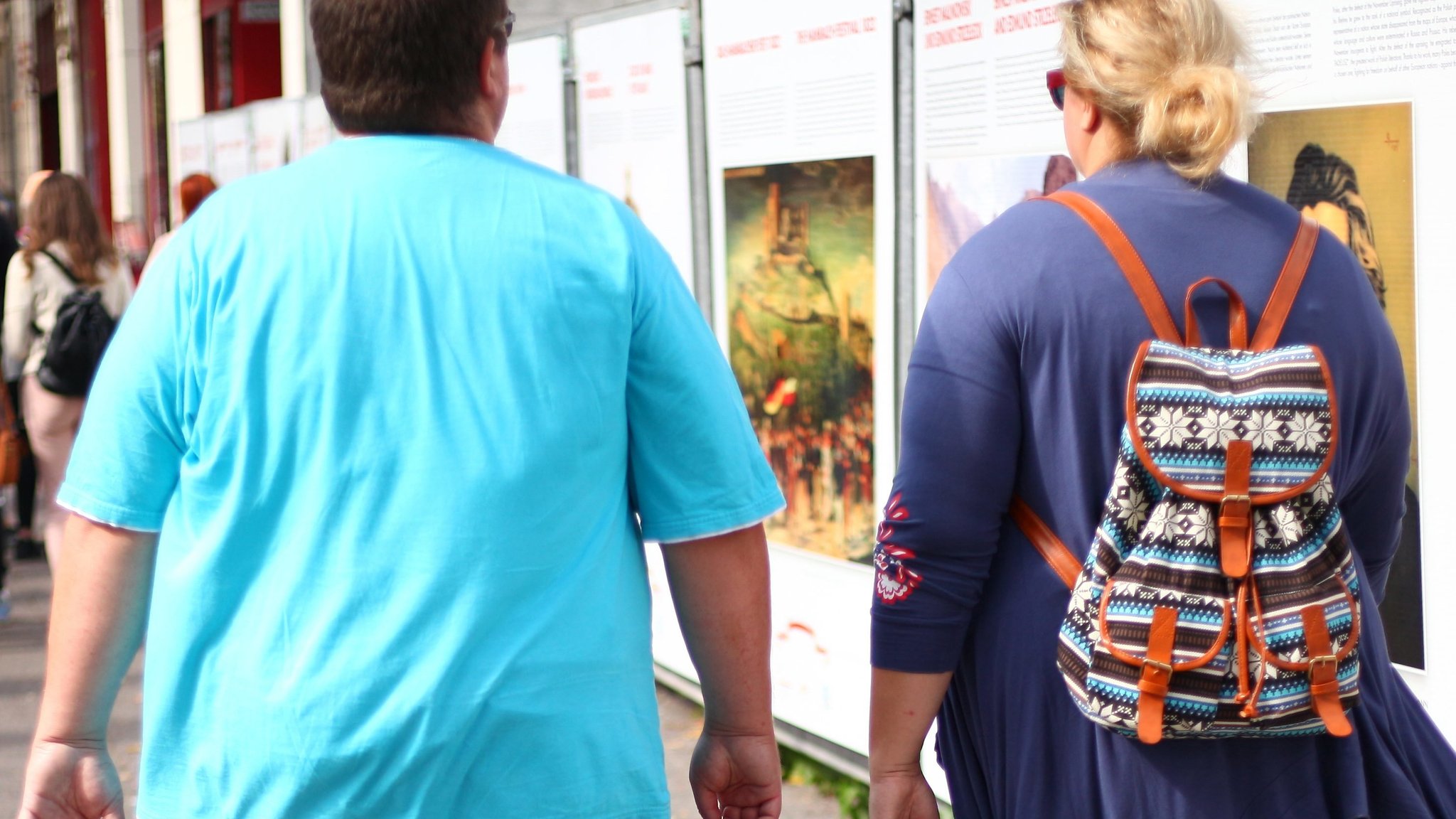 Übergewichtige Junge mit Frau beim Stadtbummel