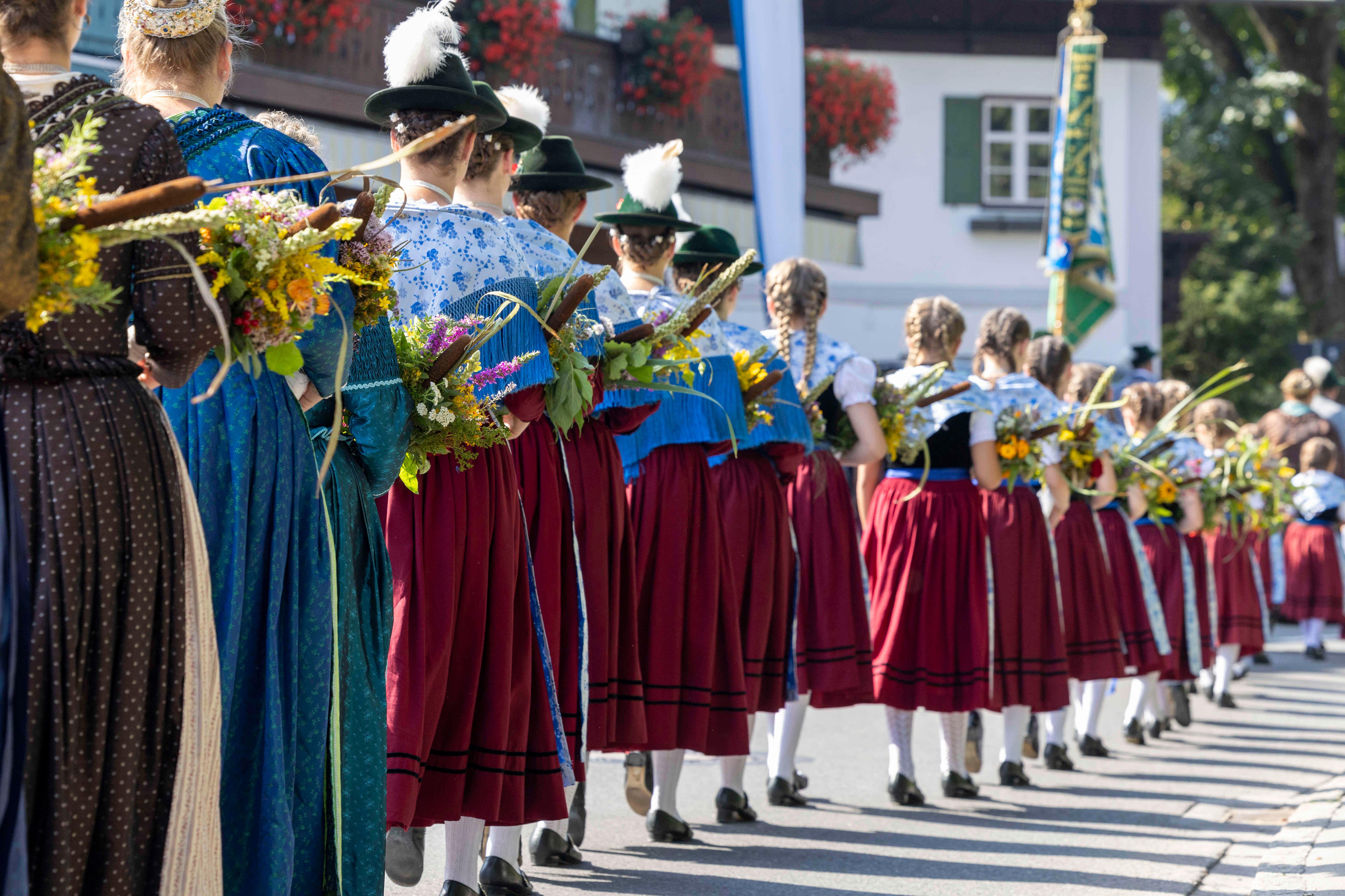 In Tracht gekleidete Maedchen und Frauen ziehen beim großen Trachtenfestzug an Mariae Himmelfahrt durch Kochel am See
