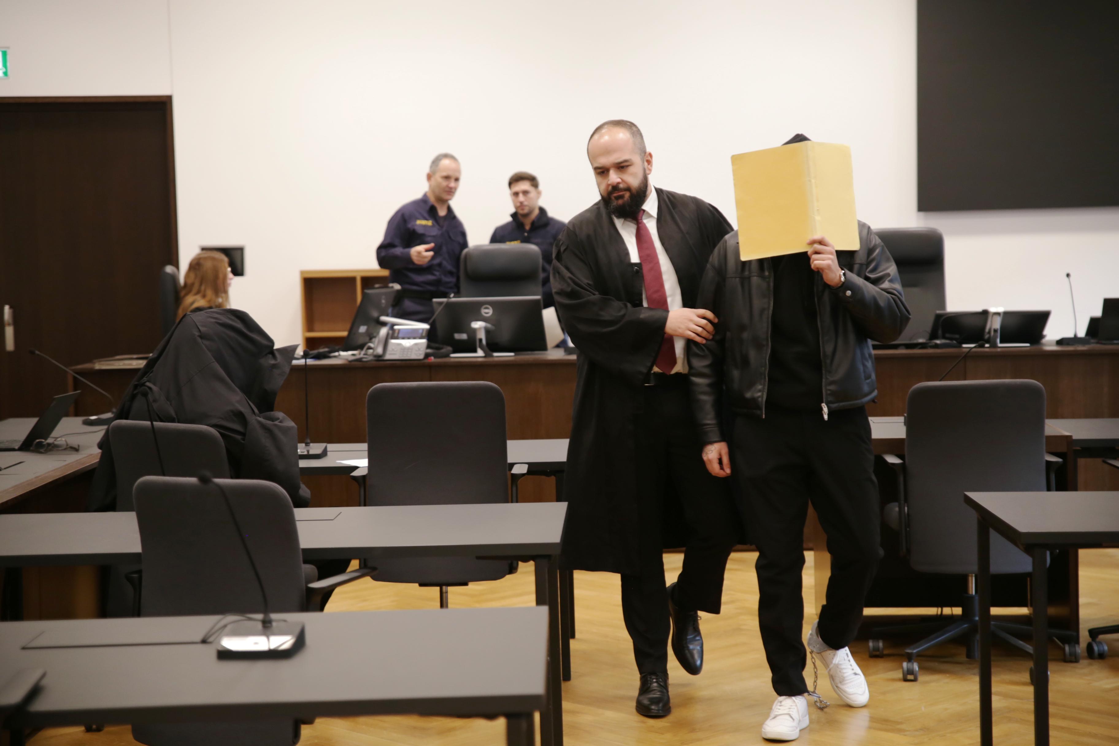 Der Anwalt führt seinen Mandanten ins Gericht. 