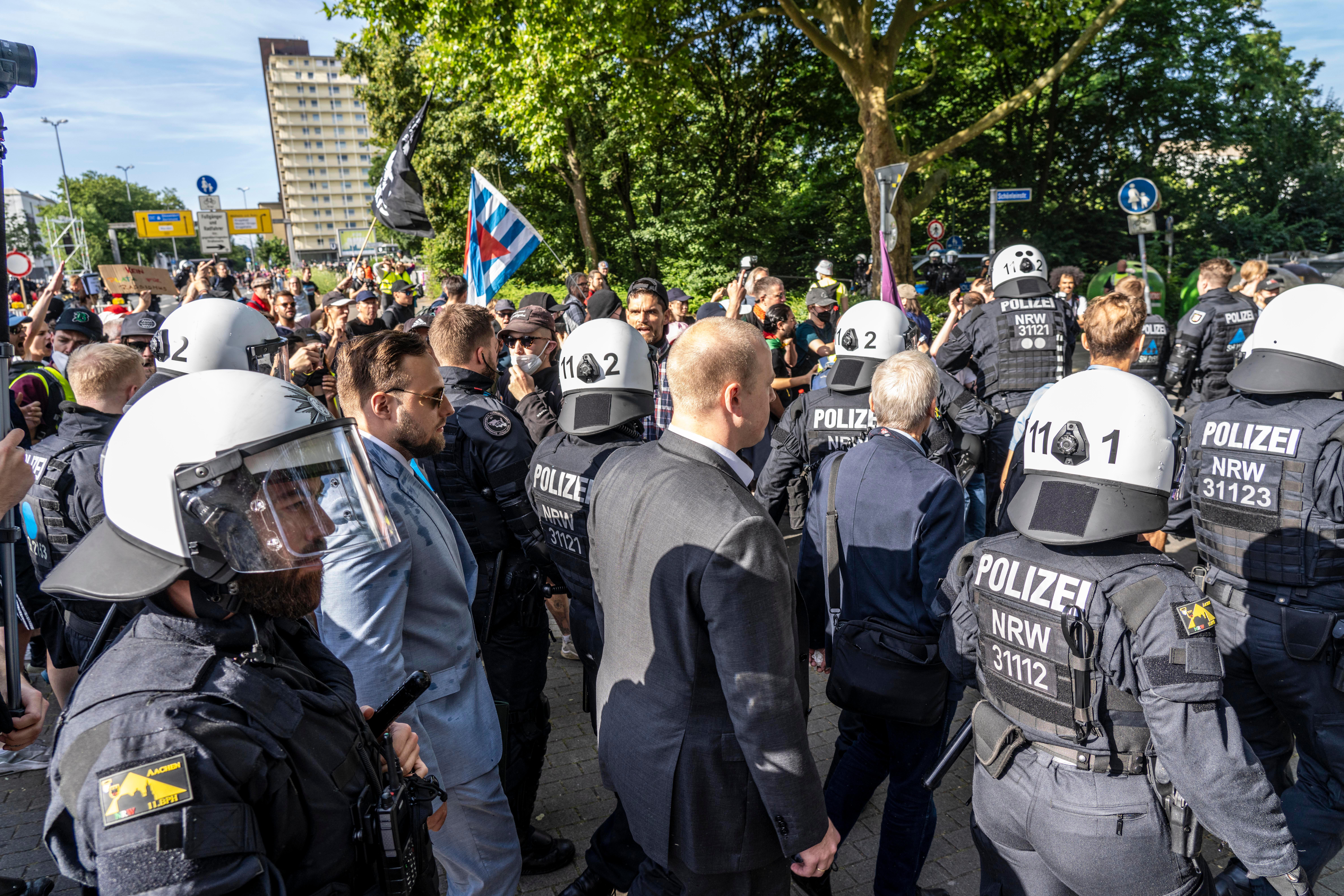 Polizisten begleiten AfD-Delegierte auf dem Weg zum Parteitag in Essen.