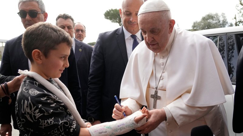 Papst Franziskus unterschreibt den Gipsabdruck eines Kindes, als er das Agostino-Gemelli-Universitätskrankenhaus in Rom verlässt.