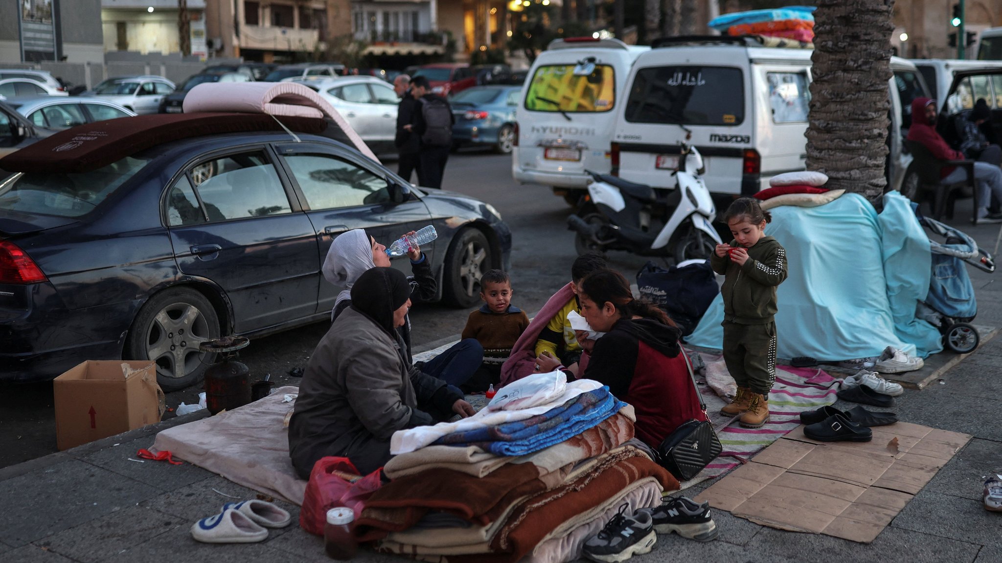 Reem, Fatima, Abd Alkader, Jaafer, Noor and Reem break their fast at iftar during Ramadan, as they sit on the street where they have been living following an escalation between Hezbollah and Israel amid the U.S.-Israeli conflict with Iran, in Beirut, Lebanon, March 10, 2026.