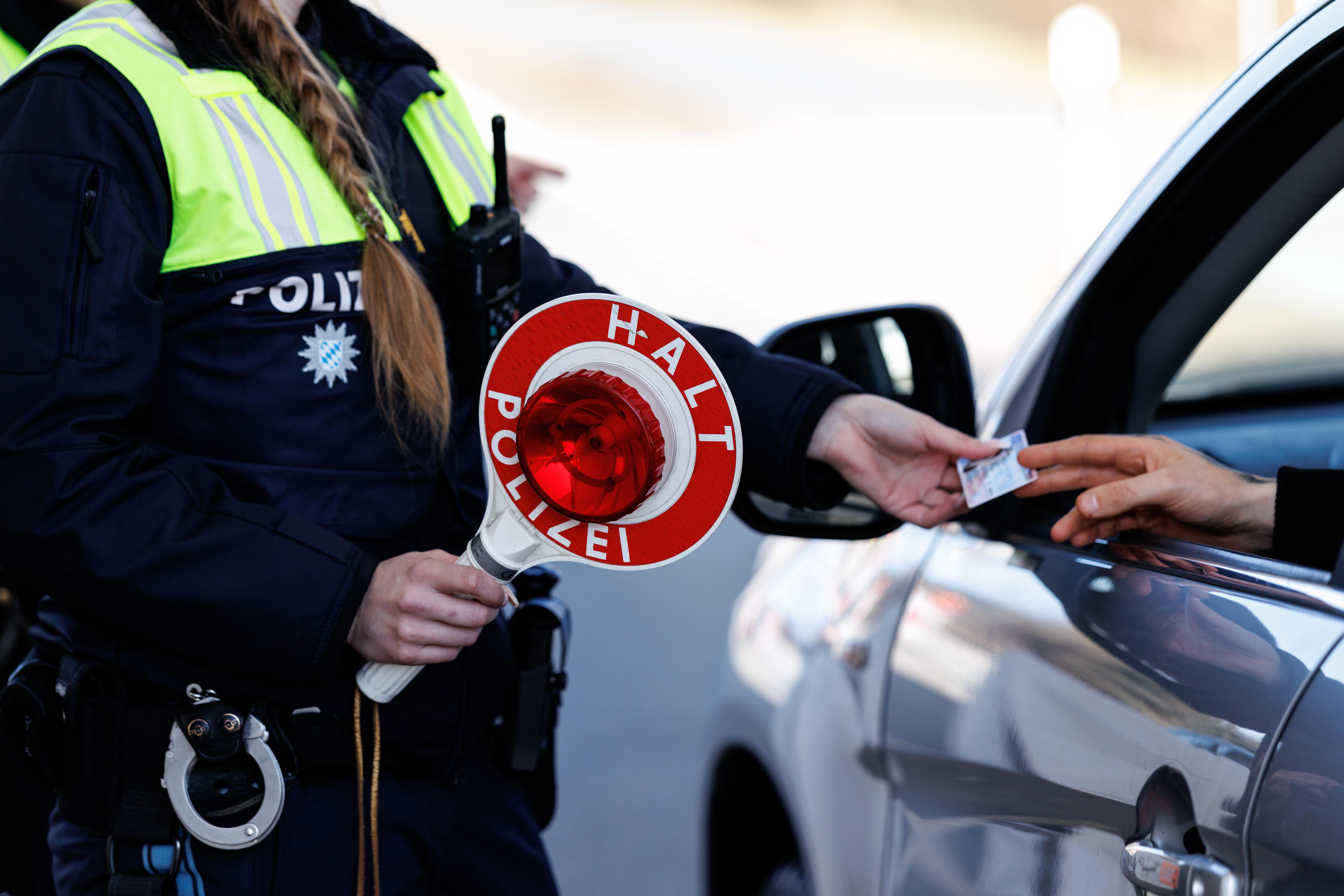(Symbolbild) Eine Polizistin der Bayerischen Grenzpolizei kontrolliert am 27.02.2026 am Grenzübergang an der Staatsgrenze von Tschechien (Tschechische Republik) und der Bundesrepublik Deutschland in Waidhaus (Bayern) die Dokumente des Fahrers von einem Auto, das aus Tschechien nach Deutschland gekommen ist. 