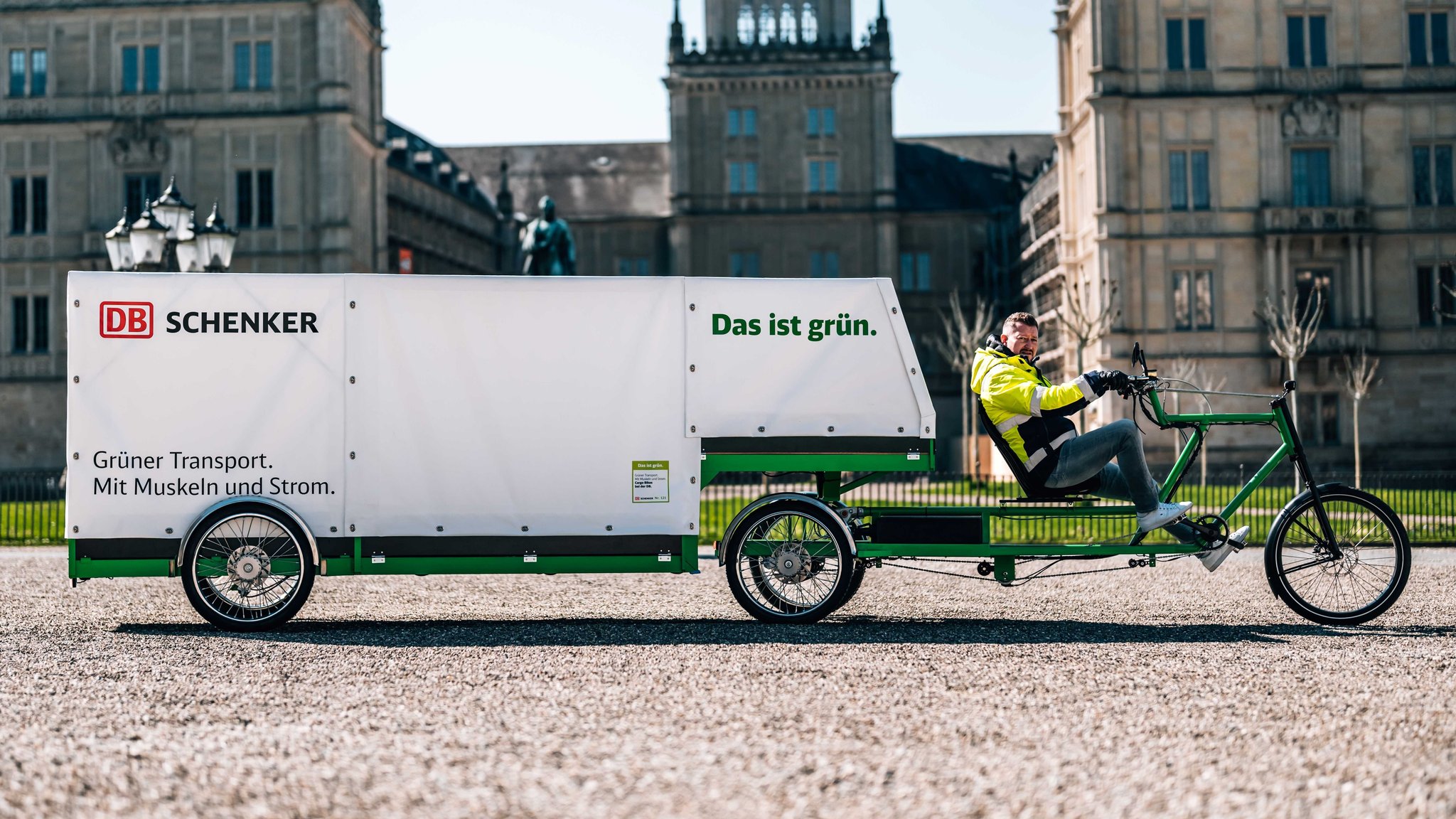 Ein Mann sitzt auf einem Fahrrad mit langem Auflieger.