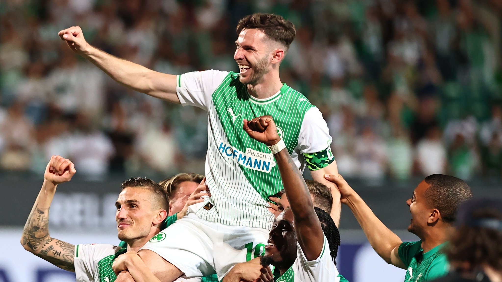 26.05.2026, Bayern, Fürth: Fußball, Männer: 2. Bundesliga - Relegation, SpVgg Greuther Fürth - Rot-Weiss Essen, Philipp Ziereis (SpVgg Greuther Fürth), Branimir Hrgota (SpVgg Greuther Fürth) und Noel Futkeu (SpVgg Greuther Fürth) (l-r) feiern nach der Partie. Foto: Daniel Karmann/dpa - WICHTIGER HINWEIS: Gemäß den Vorgaben der DFL Deutsche Fußball Liga bzw. des DFB Deutscher Fußball-Bund ist es untersagt, in dem Stadion und/oder vom Spiel angefertigte Fotoaufnahmen in Form von Sequenzbildern und/oder videoähnlichen Fotostrecken zu verwerten bzw. verwerten zu lassen. +++ dpa-Bildfunk +++ | Bild: dpa-Bildfunk/Daniel Karmann 26.05.2026, Bayern, Fürth: Fußball, Männer: 2. Bundesliga - Relegation, SpVgg Greuther Fürth - Rot-Weiss Essen, Philipp Ziereis (SpVgg Greuther Fürth), Branimir Hrgota (SpVgg Greuther Fürth) und Noel Futkeu (SpVgg Greuther Fürth) (l-r) feiern nach der Partie. Foto: Daniel Karmann/dpa - WICHTIGER HINWEIS: Gemäß den Vorgaben der DFL Deutsche Fußball Liga bzw. des DFB Deutscher Fußball-Bund ist es untersagt, in dem Stadion und/oder vom Spiel angefertigte Fotoaufnahmen in Form von Sequenzbildern und/oder videoähnlichen Fotostrecken zu verwerten bzw. verwerten zu lassen. +++ dpa-Bildfunk +++