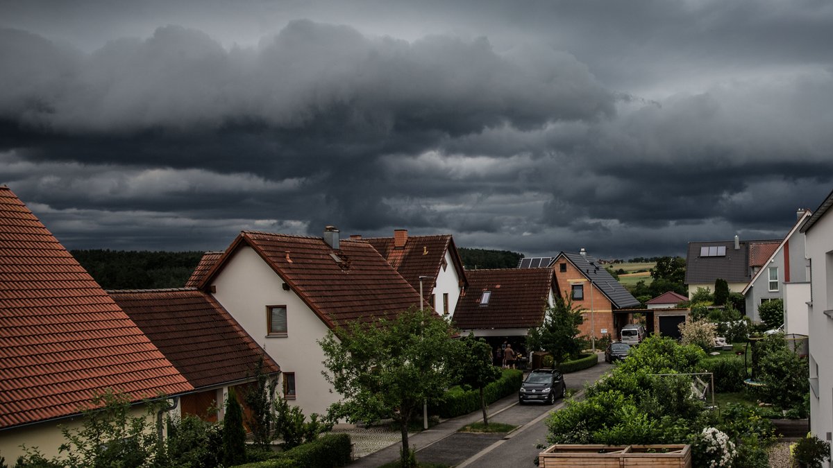 Bamberg, Deutschland 29. Juni 2021: Ein schweres Unwetter mit dunklen Wolken rollt auf Bamberg zu. Am Himmel sind dunkle Gewitterwolken zu sehen, der Vordergrund des Bildes zeigt ein Wohngebiet.