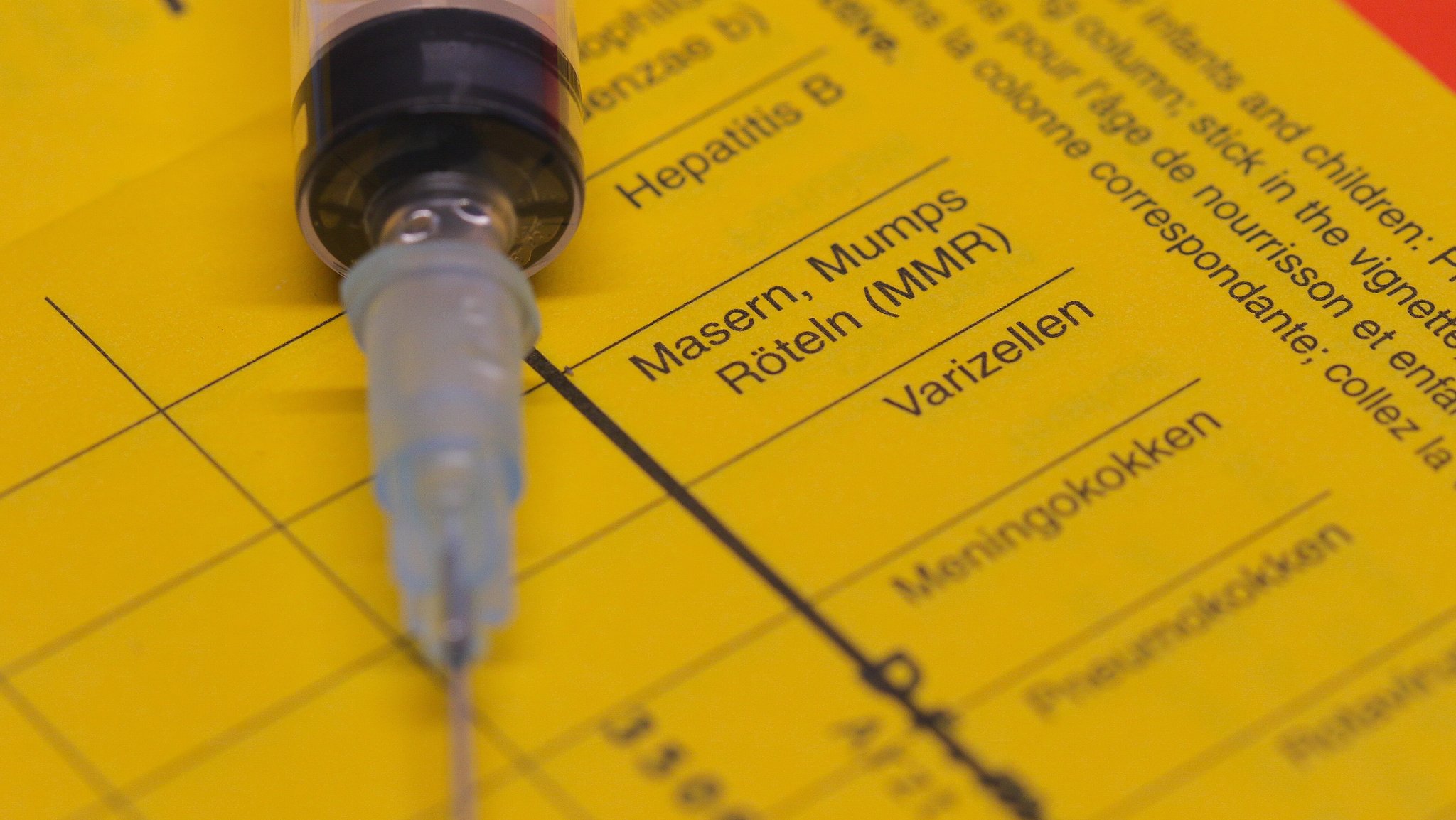 Auf einem Impfpass für Standardimpfungen nach den aktuellen Empfehlungen der Ständigen Impfkommission, liegt eine Spritze mit Kanüle. | Bild: picture alliance / Fotostand | Fotostand / Freitag Auf einem Impfpass für Standardimpfungen nach den aktuellen Empfehlungen der Ständigen Impfkommission, liegt eine Spritze mit Kanüle.