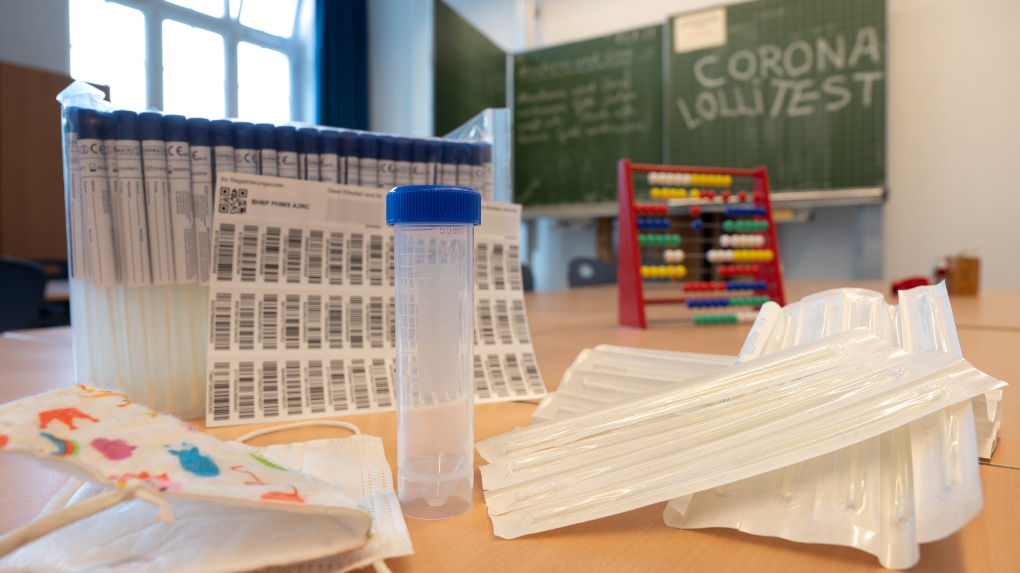 Ein komplettes, unbenutztes Set des sogenannten "Lolli-Test" (PCR-Pooltest) steht im Klasenzimmer einer bayerischen Grundschule.