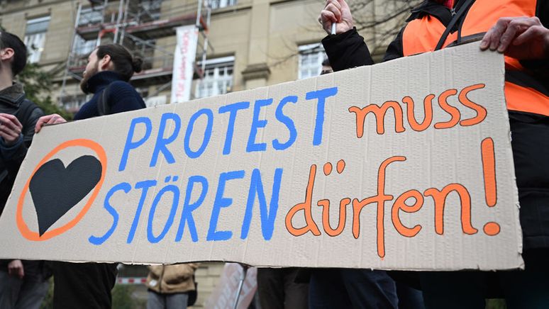 Klimaaktivisten der Letzten Generation protestieren vor dem Oberlandesgericht (OLG) Karlsruhe gegen den Prozess, ob Straßenblockaden von Klimaaktivisten als Nötigung einzustufen sind.  | Bild:dpa-Bildfunk/Uli Deck