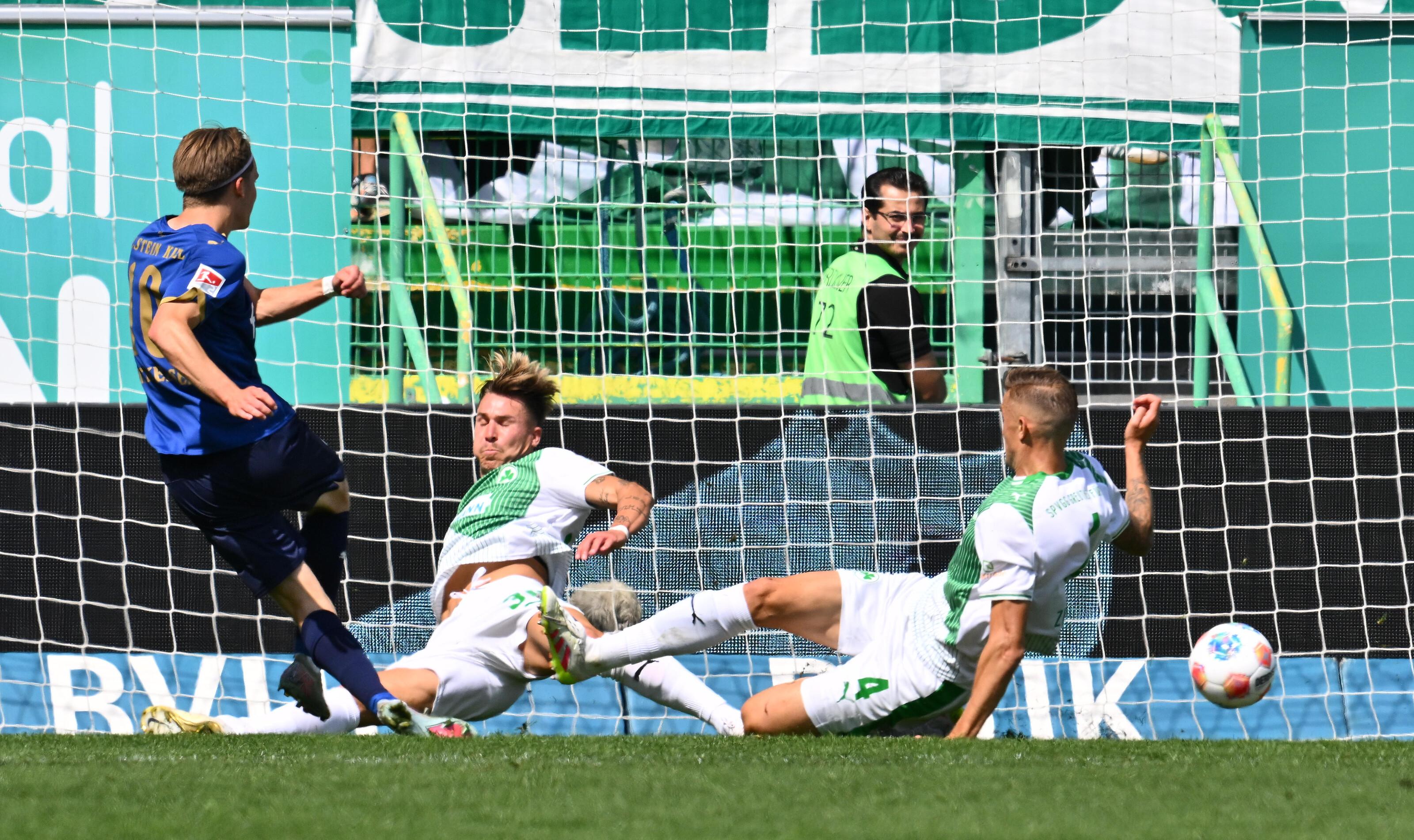 Jonas Therkelsen trifft zur Führung für Holstein Kiel. Die Fürther Felix Klauß (Mitte) und Philip Ziereis haben das Nachsehen.